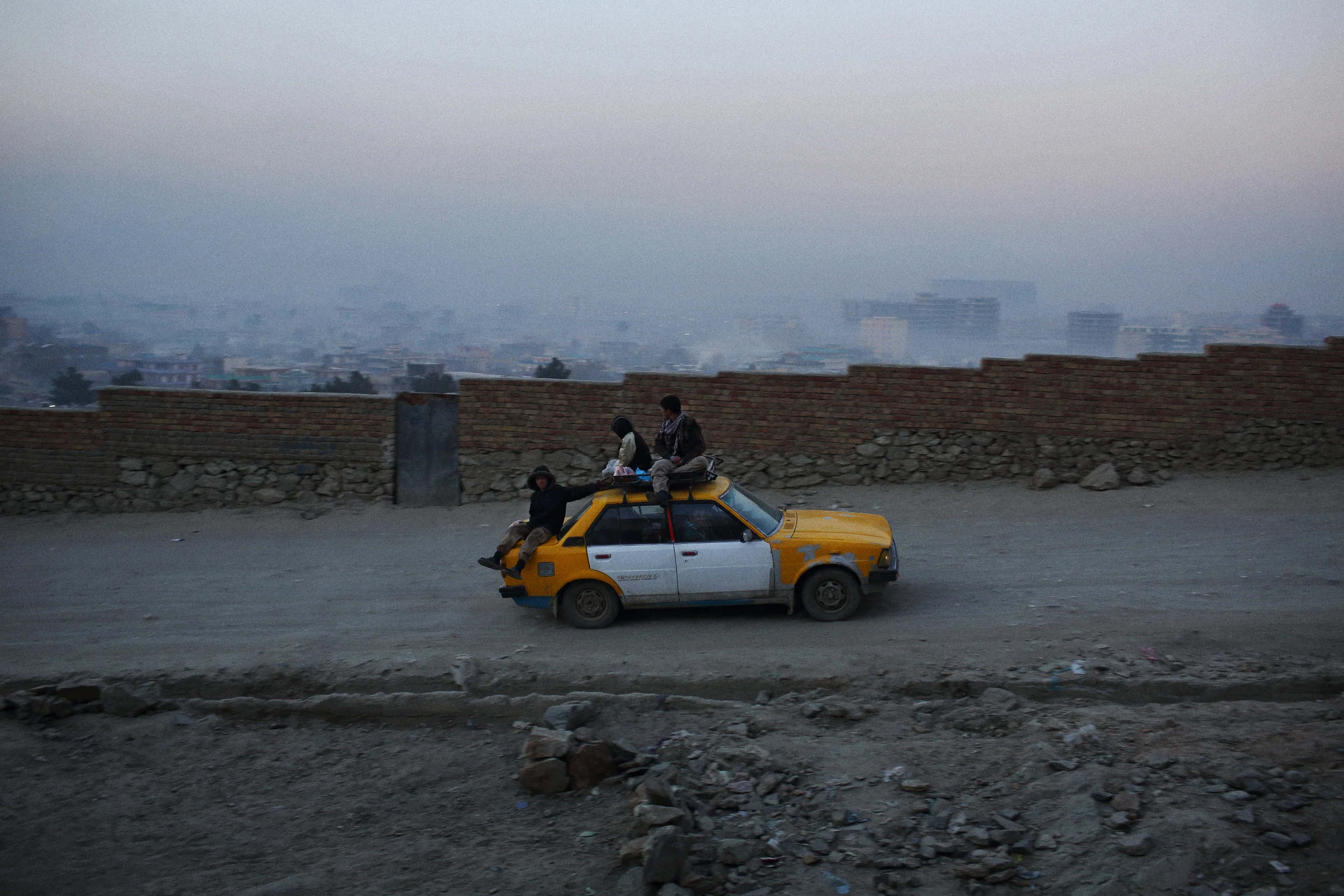  Hitching a ride up ‘TV Mountain’, where thousands of families, particularly from north of Kabul, have settled, illegally, in search of work and the opportunities afforded by a big city in the years since the 2001. Kabul, December 2013 
