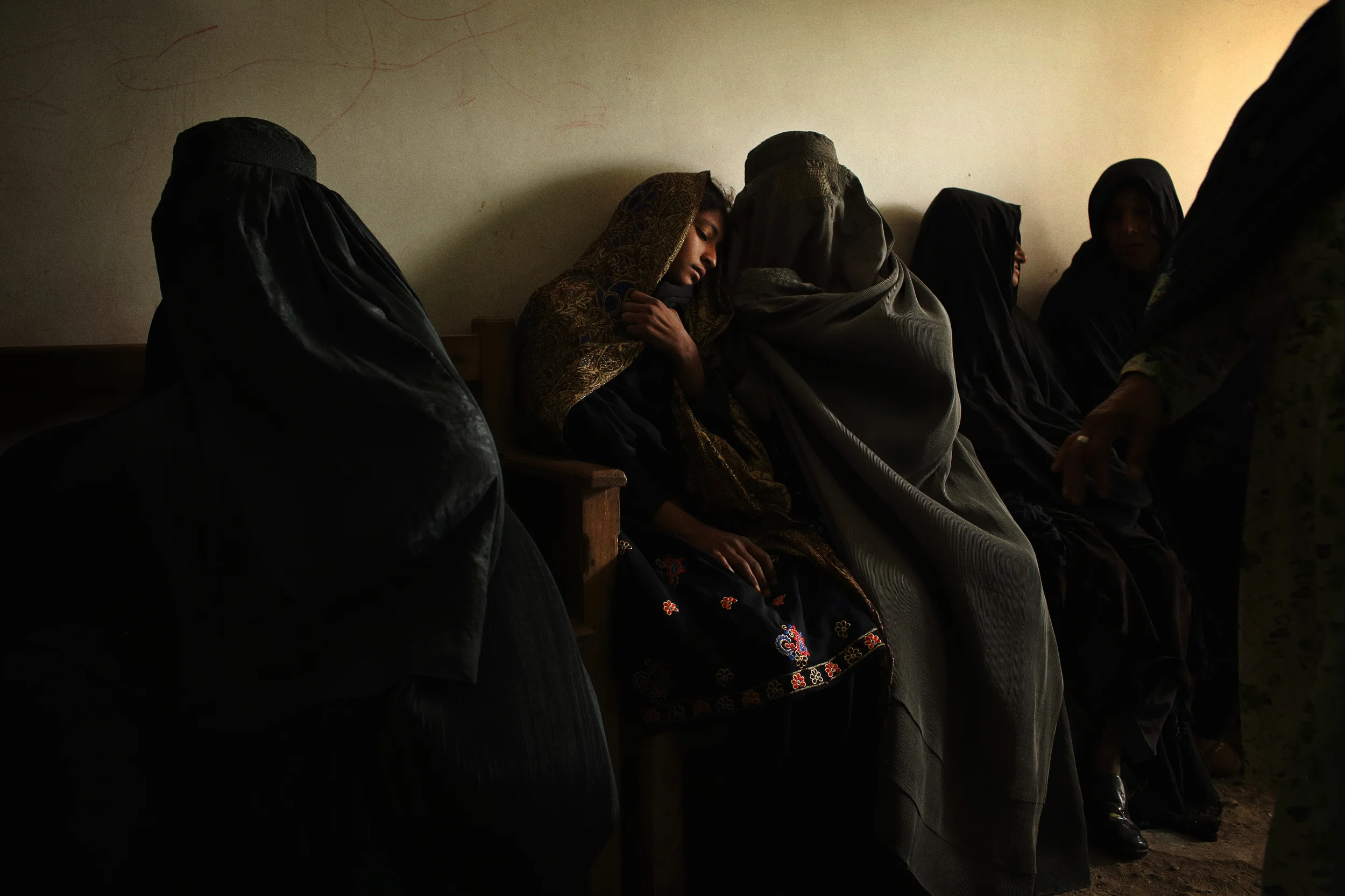  A young woman is comforted while waiting for treatment at Bost Hospital. Helmand Province, February, 2014. 