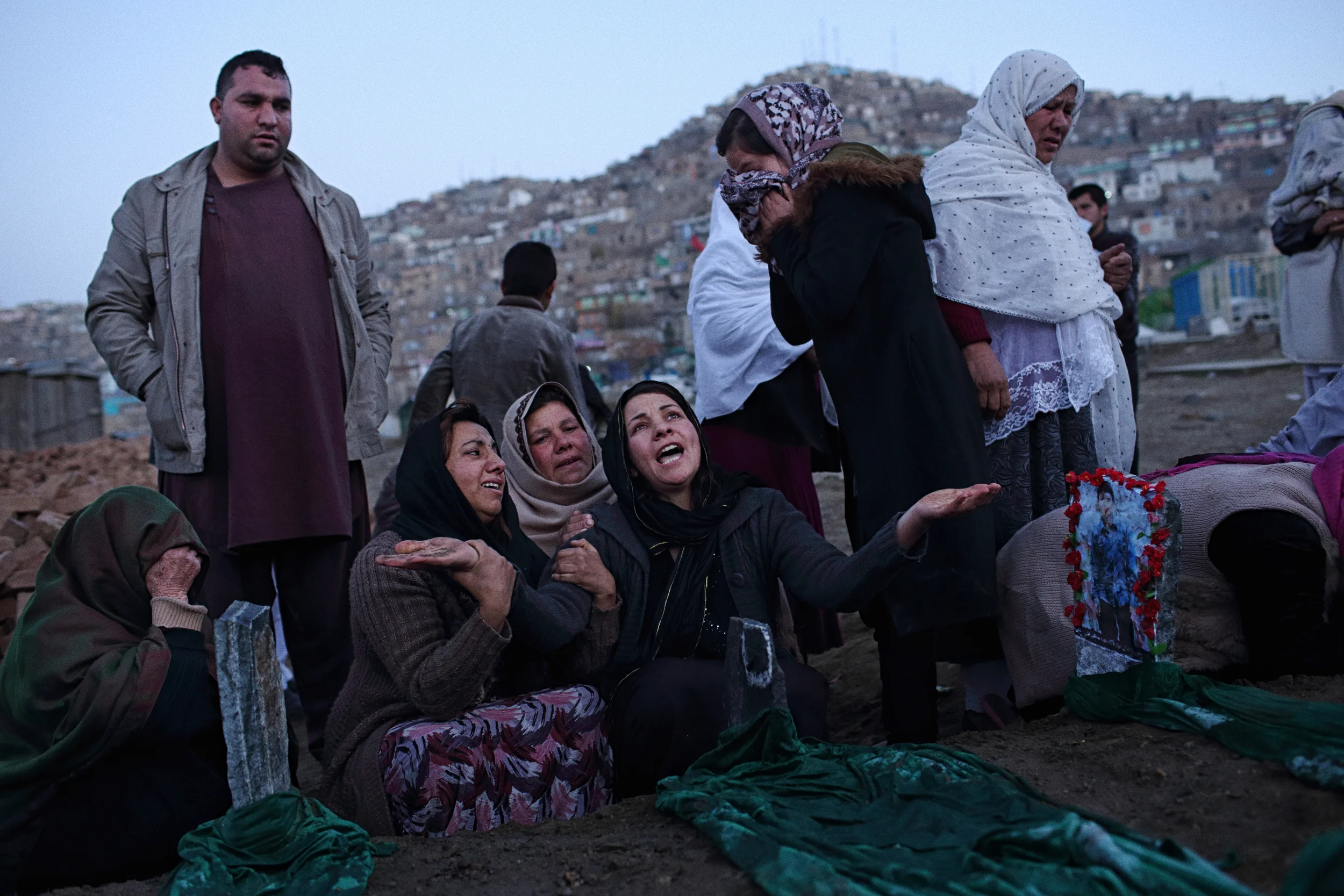  At dawn, the day after seven young boys were killed when a piece of unexploded ordinance they’d found exploded, women of the boys' families mourned at Karte-y Sakhi cemetery, where the seven were buried side by side the day before. Kabul, November 2