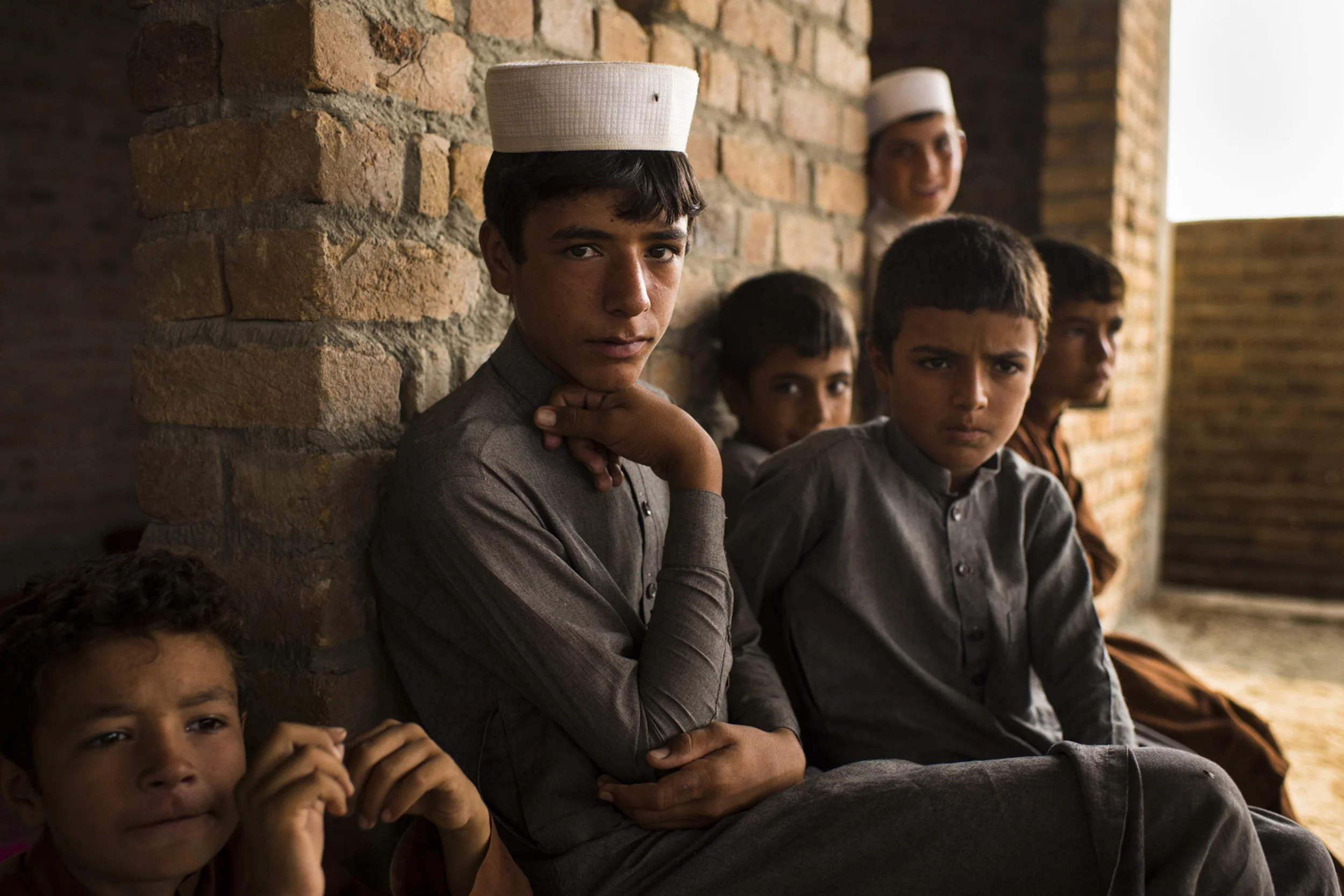  At an unfinished building site now used as a temporary home in a village known as Camp Shahr Shahi, boys from some of the many families displaced because of the presence of the so-called Islamic State in the nearby district of Achin, in eastern Afgh