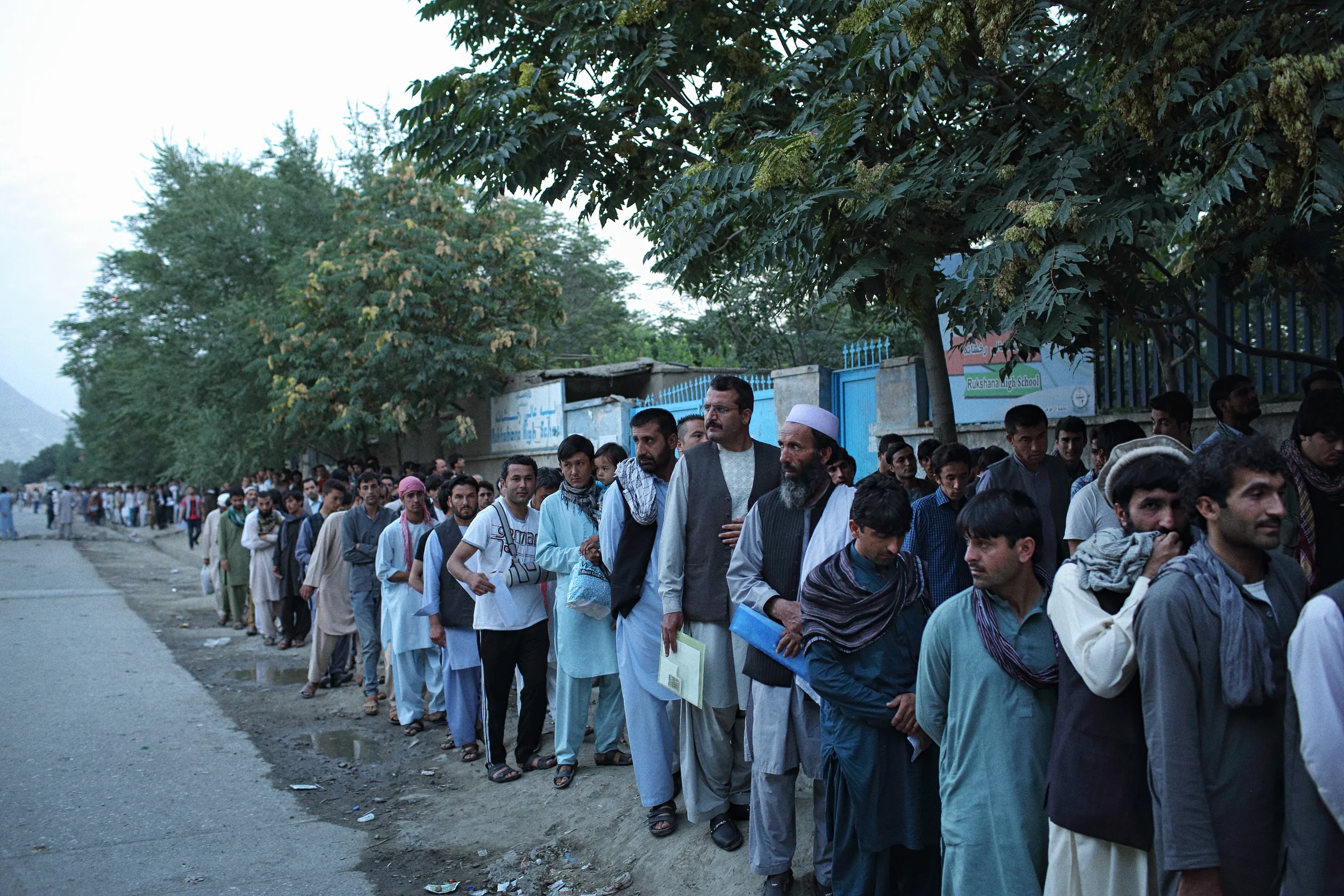  Hundreds of Afghan passport applicants queue before sunrise, outside Afghanistan's only passport office. Thousands of passports were being applied for and issued each day at the time, as an ever increasing number attempted to leave the country becau