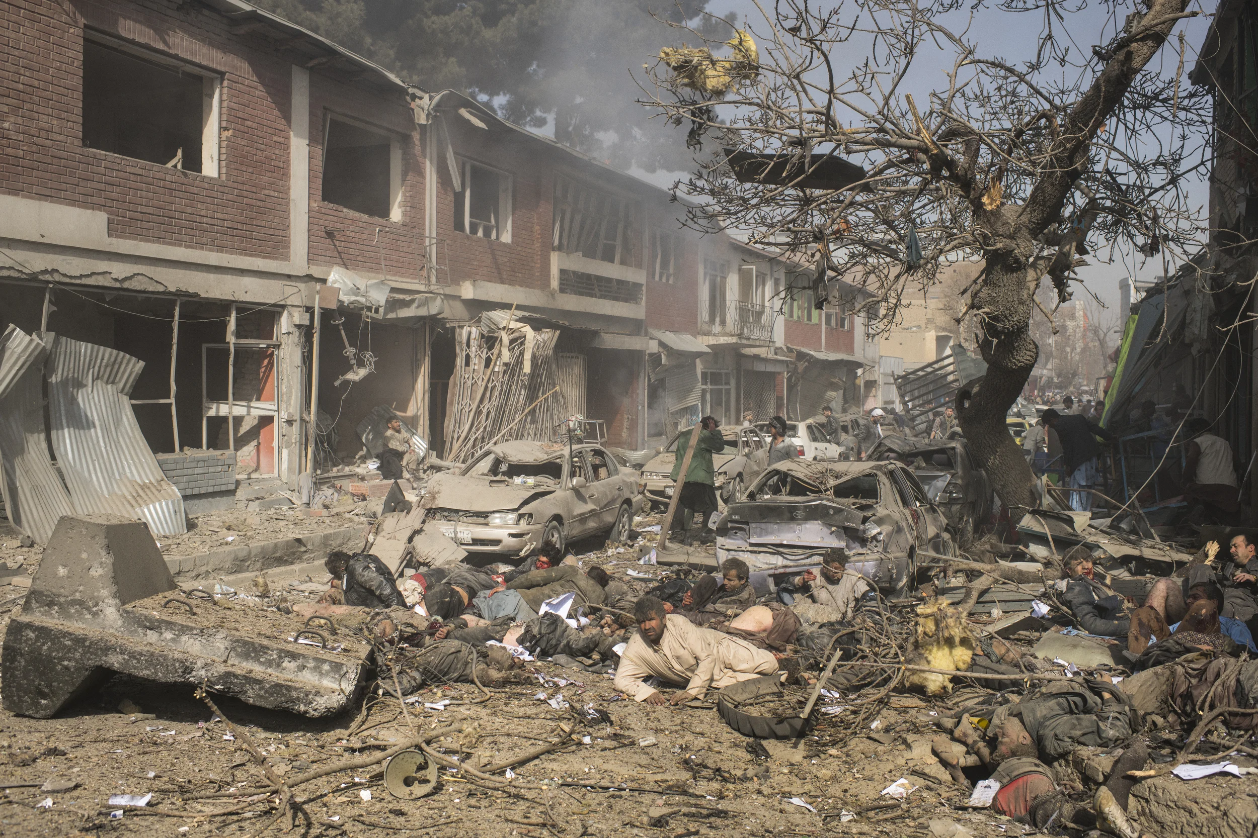  Victims lie dead and severely wounded at the site of a bomb that had been disguised inside an ambulance and detonated in an area of small businesses and a hospital in central Kabul. 103 were killed and more than 150 wounded by the bomb for which the