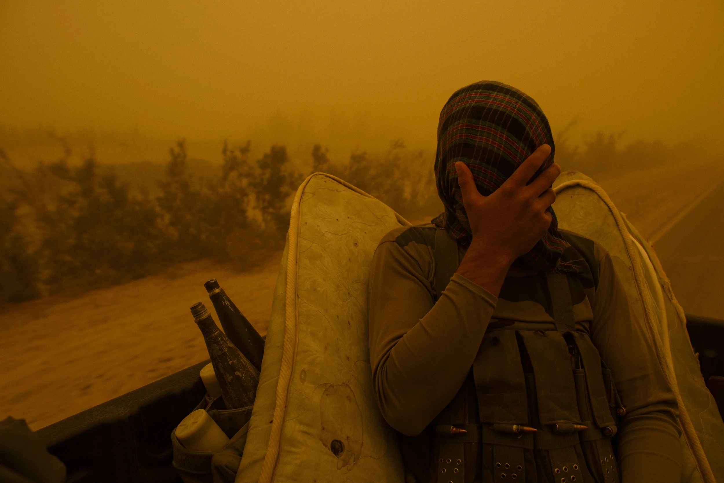 A bodyguard of Nimroz Governor Mohammad Sami covers his face from dust, en route from Zaranj to the beginnings of the Kamal Khan dam project, which, if all goes according to plan, will be filled by the Helmand River and provide much needed water to 