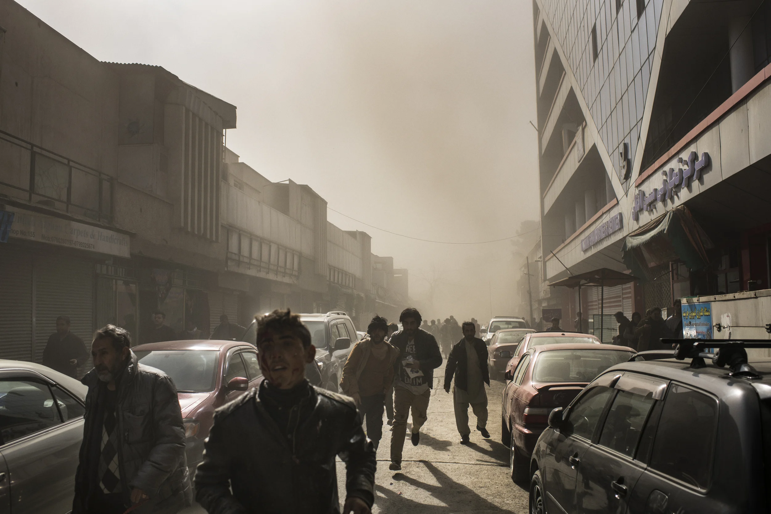  Survivors of a bombing at the opposite end Chicken Street (pictured) run for safety. Kabul, January, 2018. 