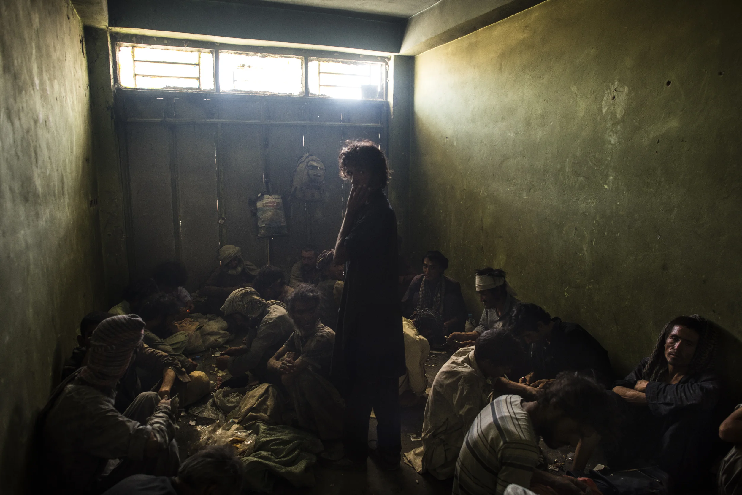  Dozens of drug addicts smoke opium and crystal methamphetamine, soon after sunrise, in a small, abandoned store-front behind the main traffic circle in Zaranj, in Afghanistan's southwest. The majority of addicts said they had become addicted in Iran