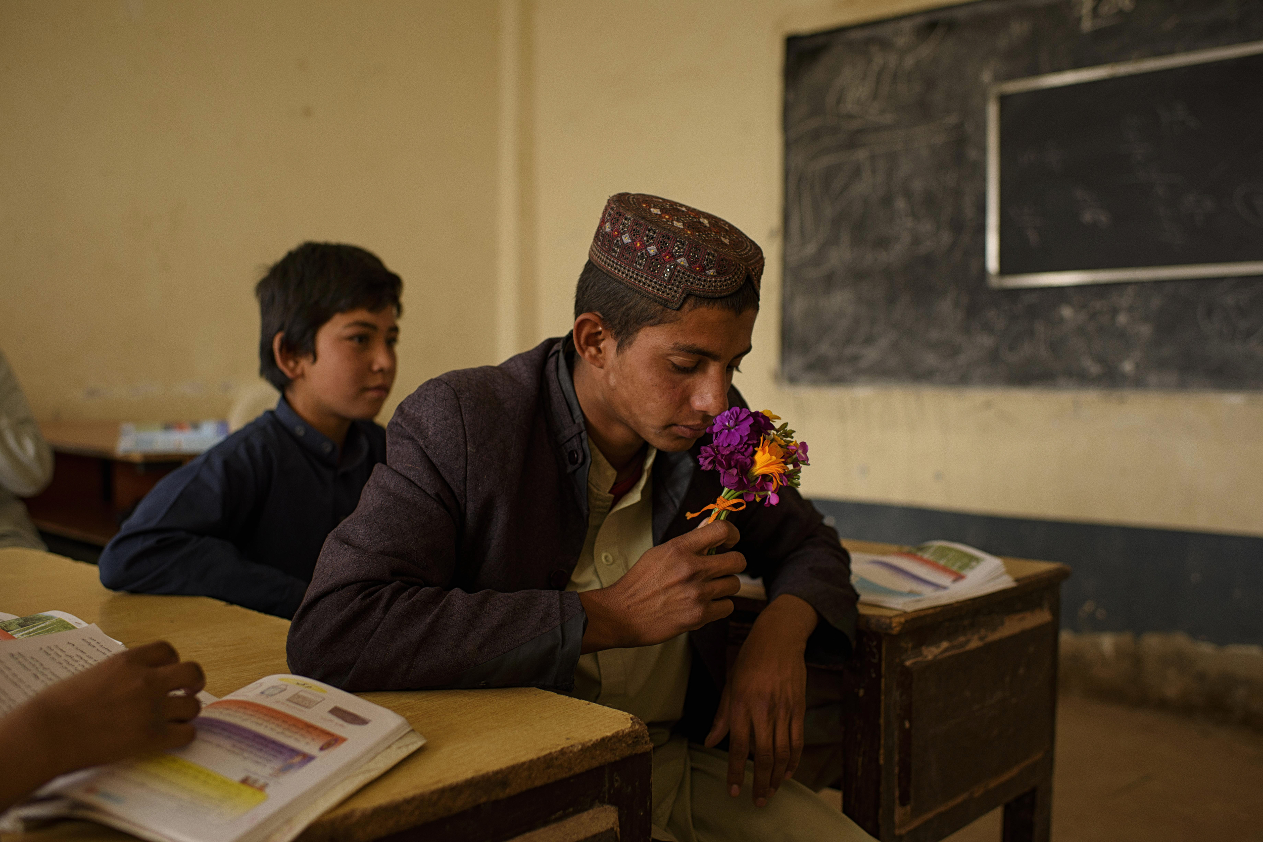  Young students in a classroom with no teacher at the Sayedabad school in Helmand's Nad-i Ali. The school was operating with government soldiers positioned on its roof, with a diminished number of students and teachers and with the sound of fighting 