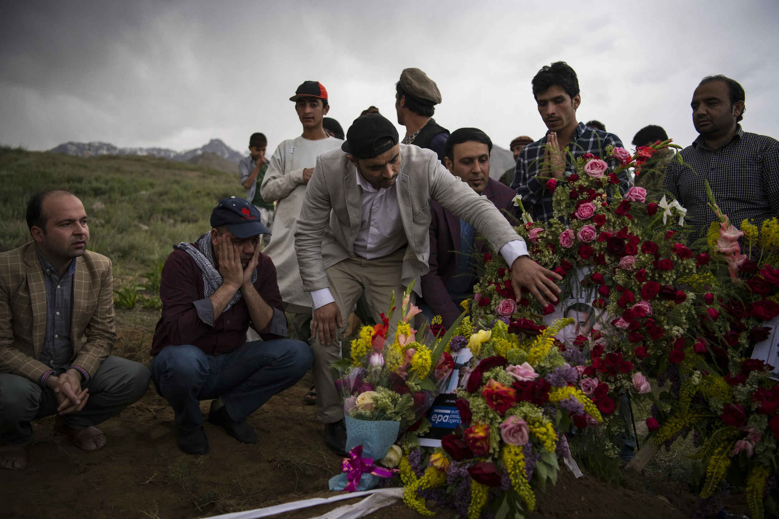  Colleagues of Shah Marai, Agence France Presse’s Chief Photographer in Afghanistan who was killed in a suicide bombing that also claimed the lives of nine other journalists, attend his burial in the family village in Guldara District on the afternoo