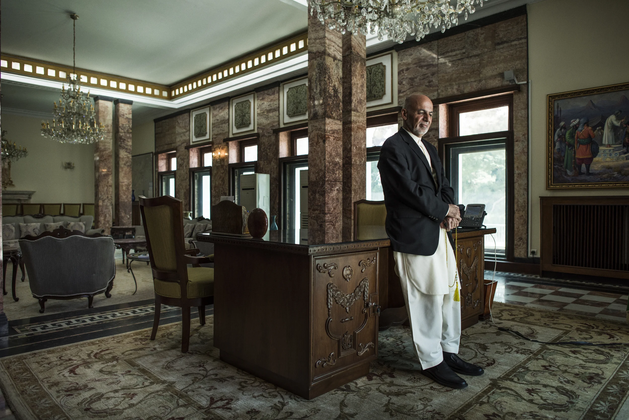  President Ashraf Ghani stands at his desk, which originally belonged to Afghanistan's leader of the early 20th century, Amanullah Khan, and which Ghani had restored when he came to office, in the Golkhana building in the presidential palace, or Arg 