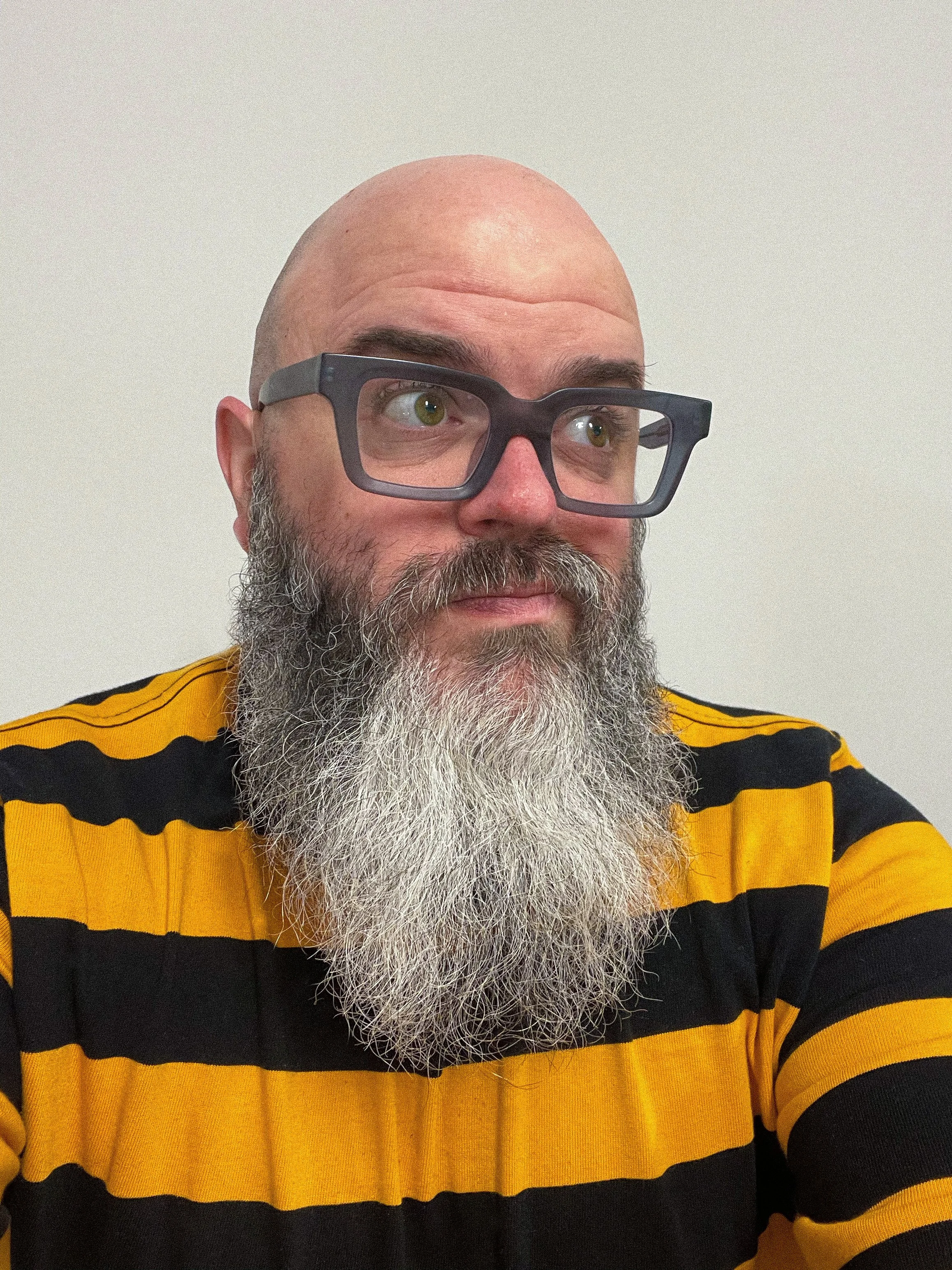 Photo of David Klotz wearing glasses and a striped shirt