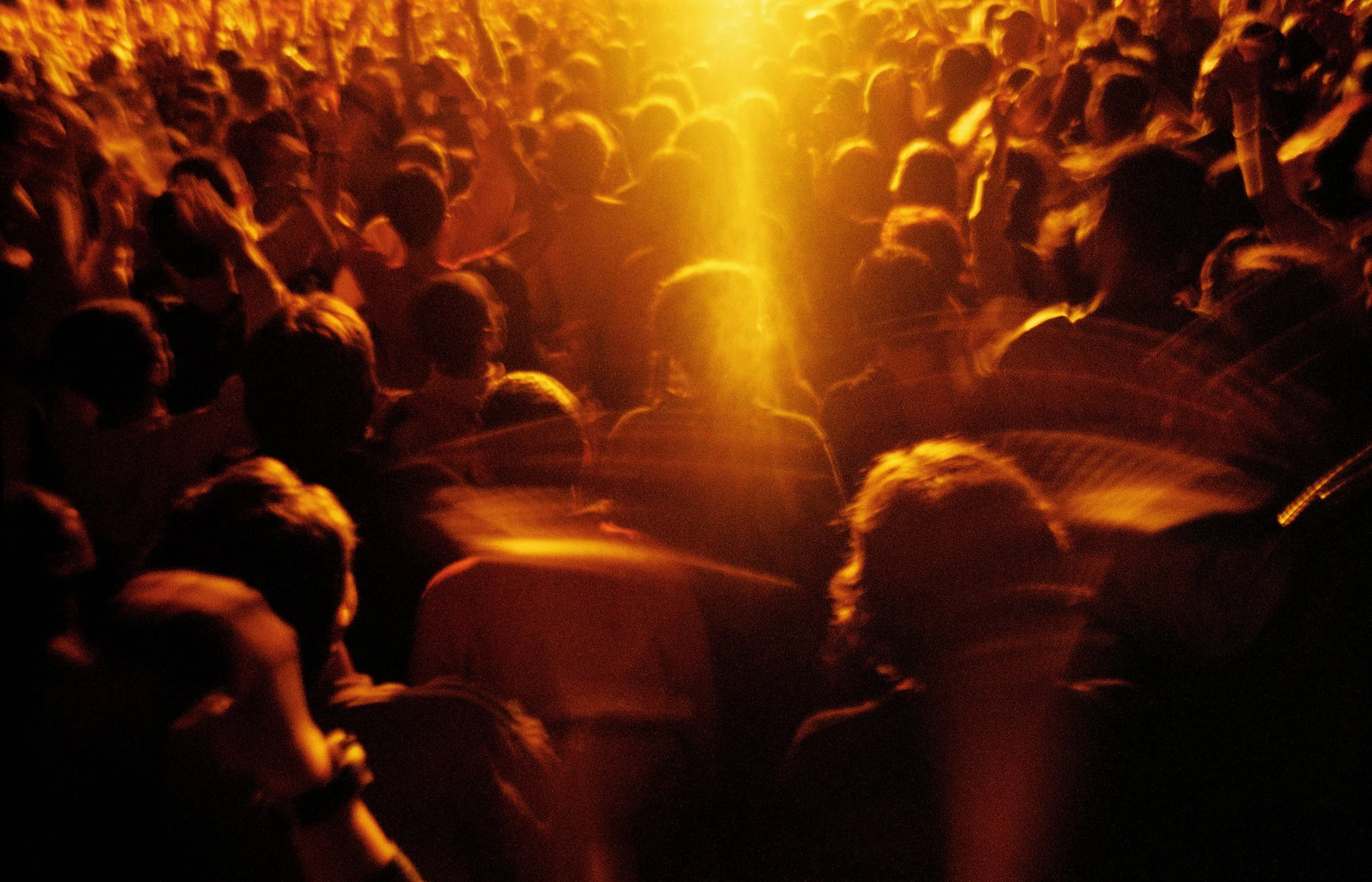 Cinematic Photography Crowd at a concert with mood and warm sunset tones.