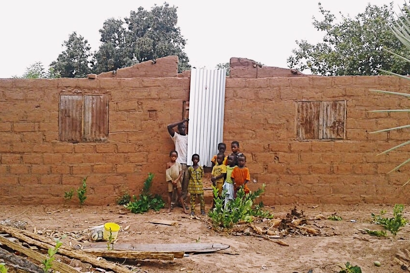  Family holding metal roof sheeting for their new home  