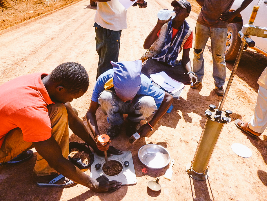  Soil scientists test the quality of soil compaction on a new road 