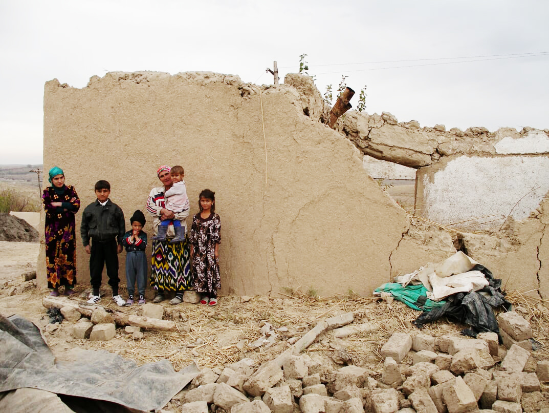  Family with the ruins of their home 