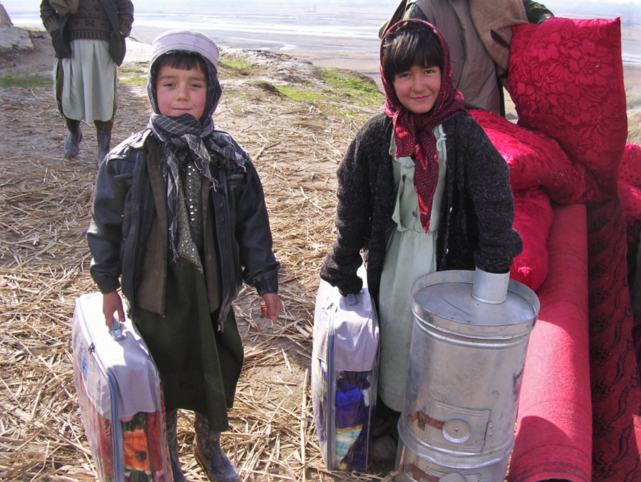 Children from Tahkar province receive stove and other winterization goods