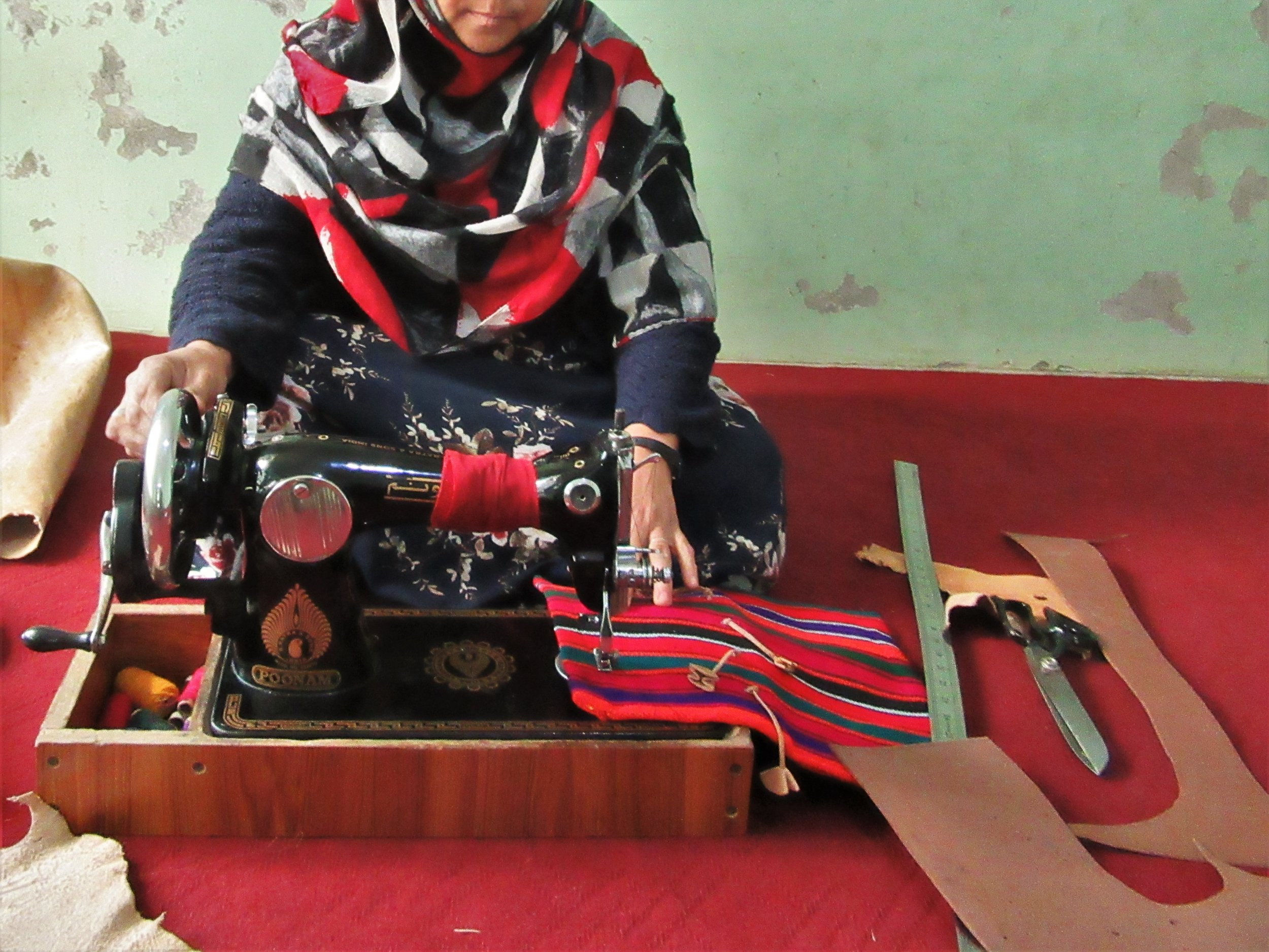 Halima working on one of the handbags she made in class