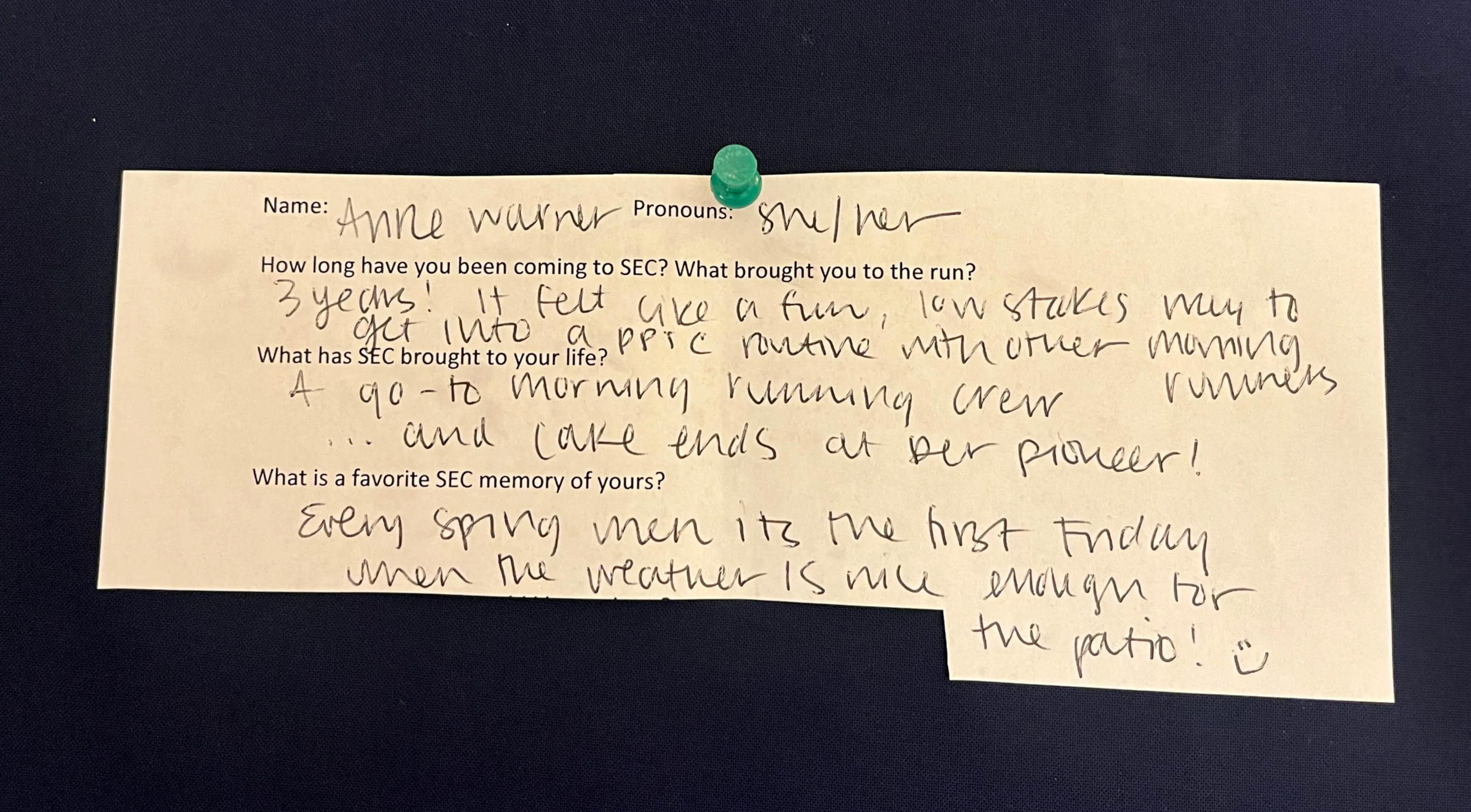An image of a slip of white printer paper with typed questions and hand written answers. The paper is pinned to a navy blue background with a green thumbtack. The contents of the writing are written below the photo.