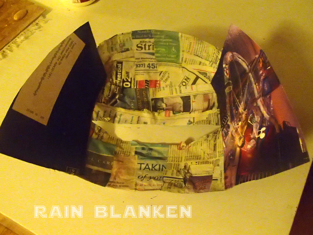 The sides of the mask started with panels of thick magazine paper.