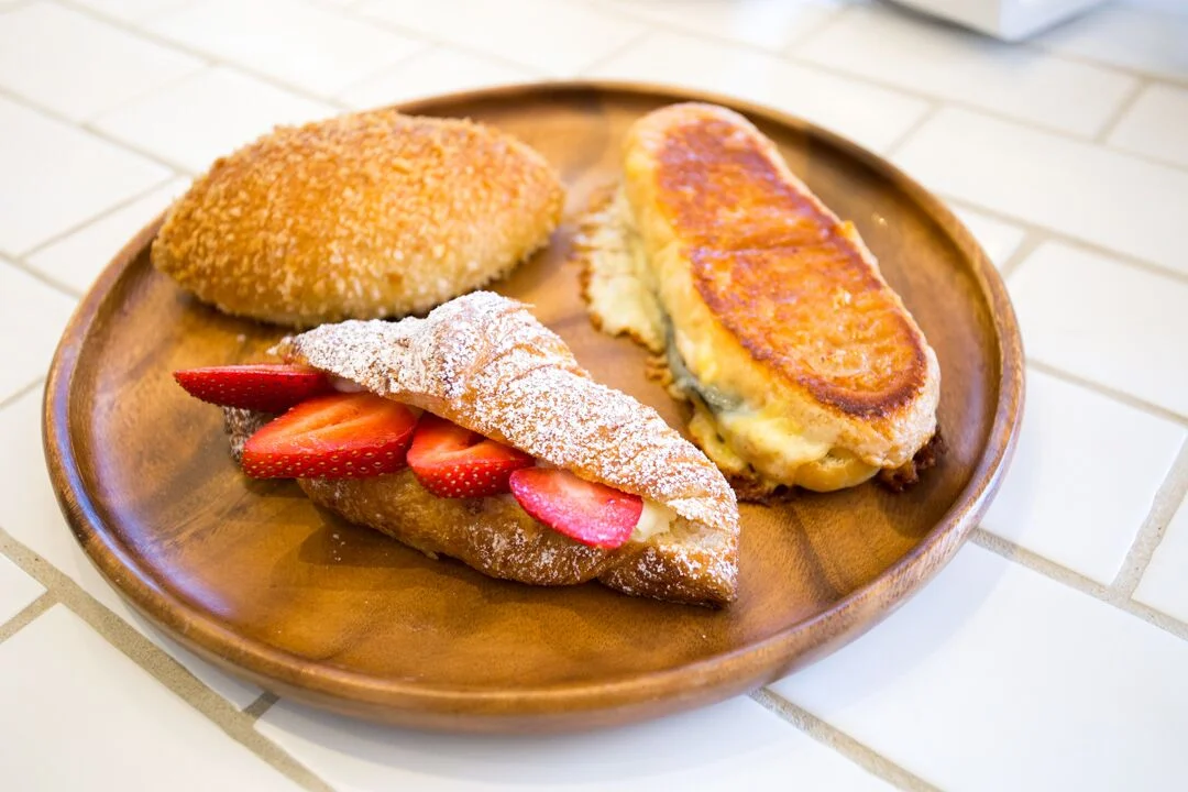 Pictured clockwise: Okayama Kobo's Japanini, Strawberry Milk Cream Croissant, Curry Pan