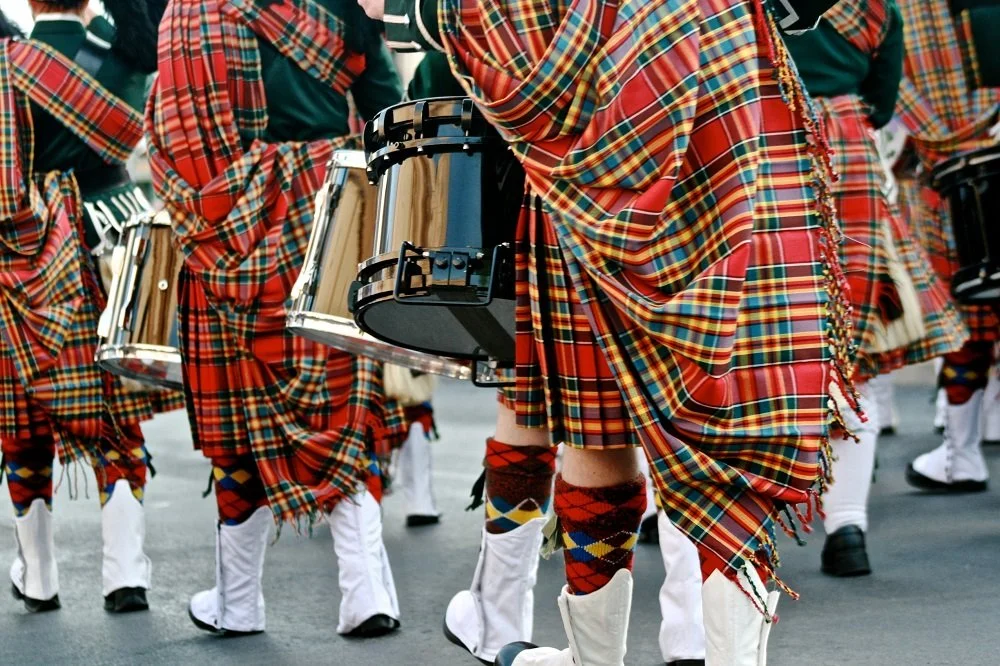 What do Scottish tartans signify?
