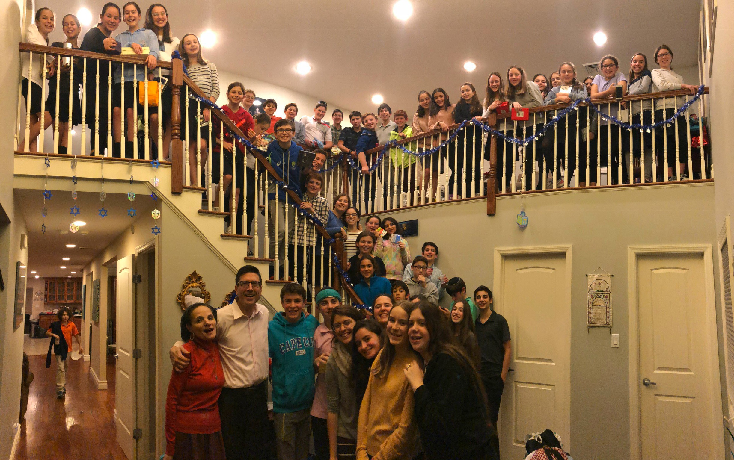 Current SAR Academy students celebrating Chanukah at the home of their teacher, Rabbi Steven Moskowitz AC ‘79