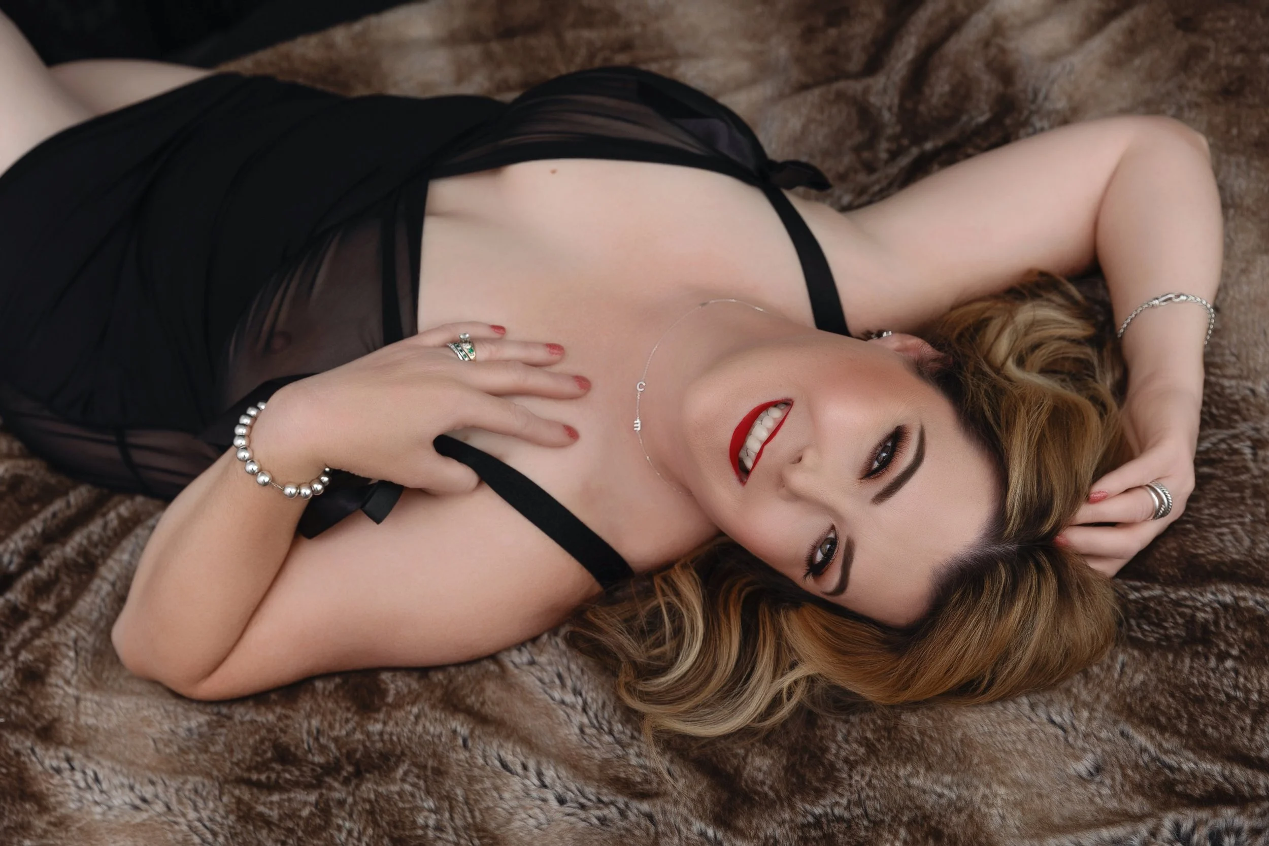 Woman feeling beautiful and confident during her boudoir session