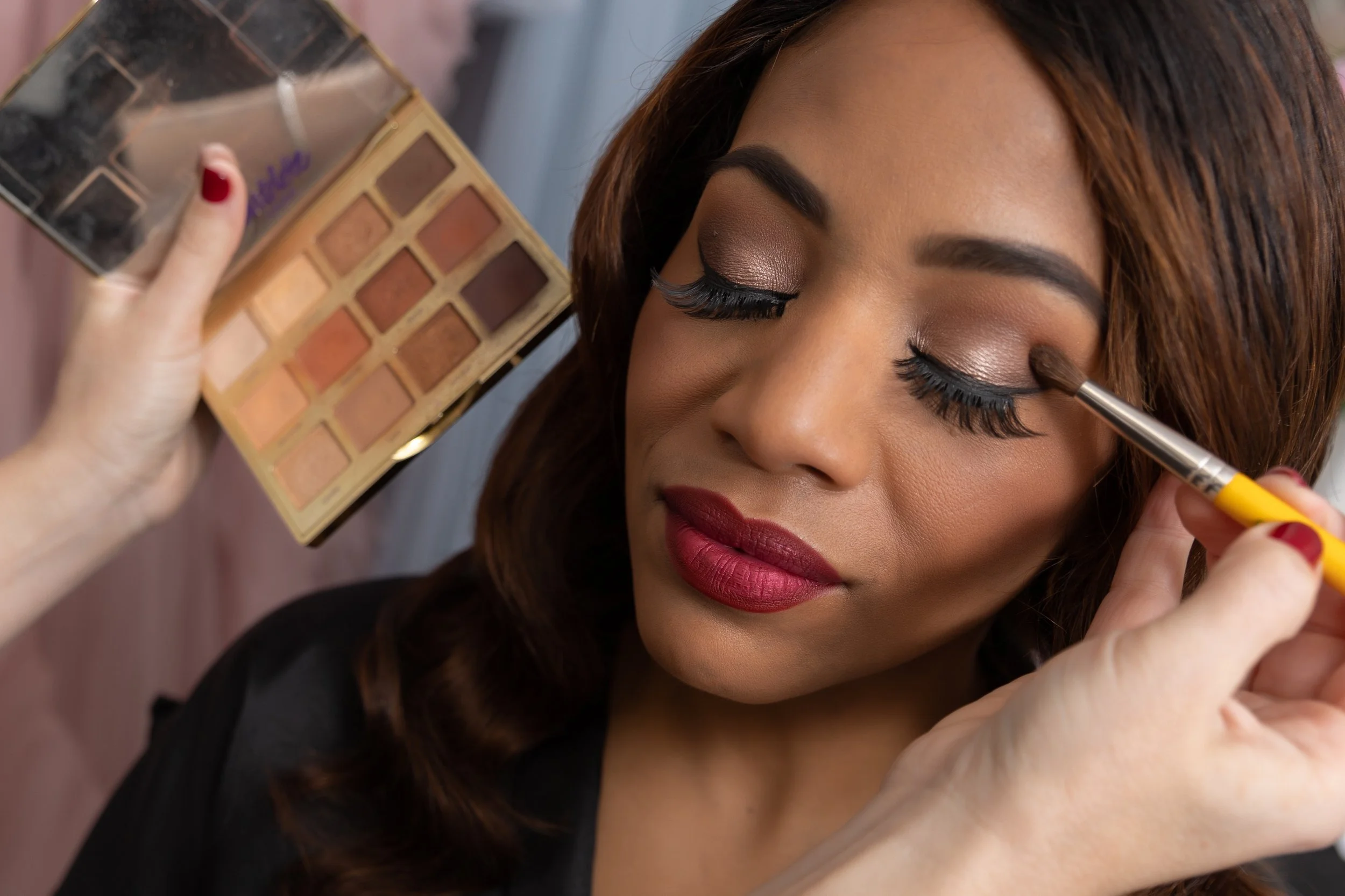 Professional makeup artist blending foundation for flawless camera-ready skin