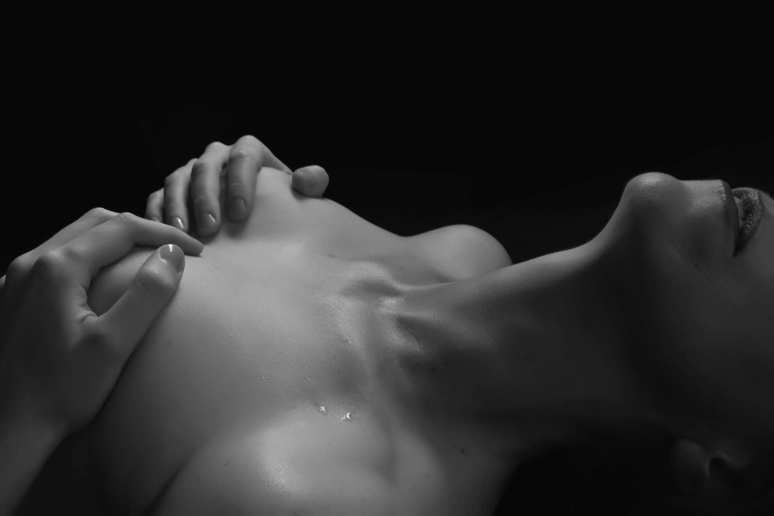 Artistic boudoir pose emphasizing shape and light