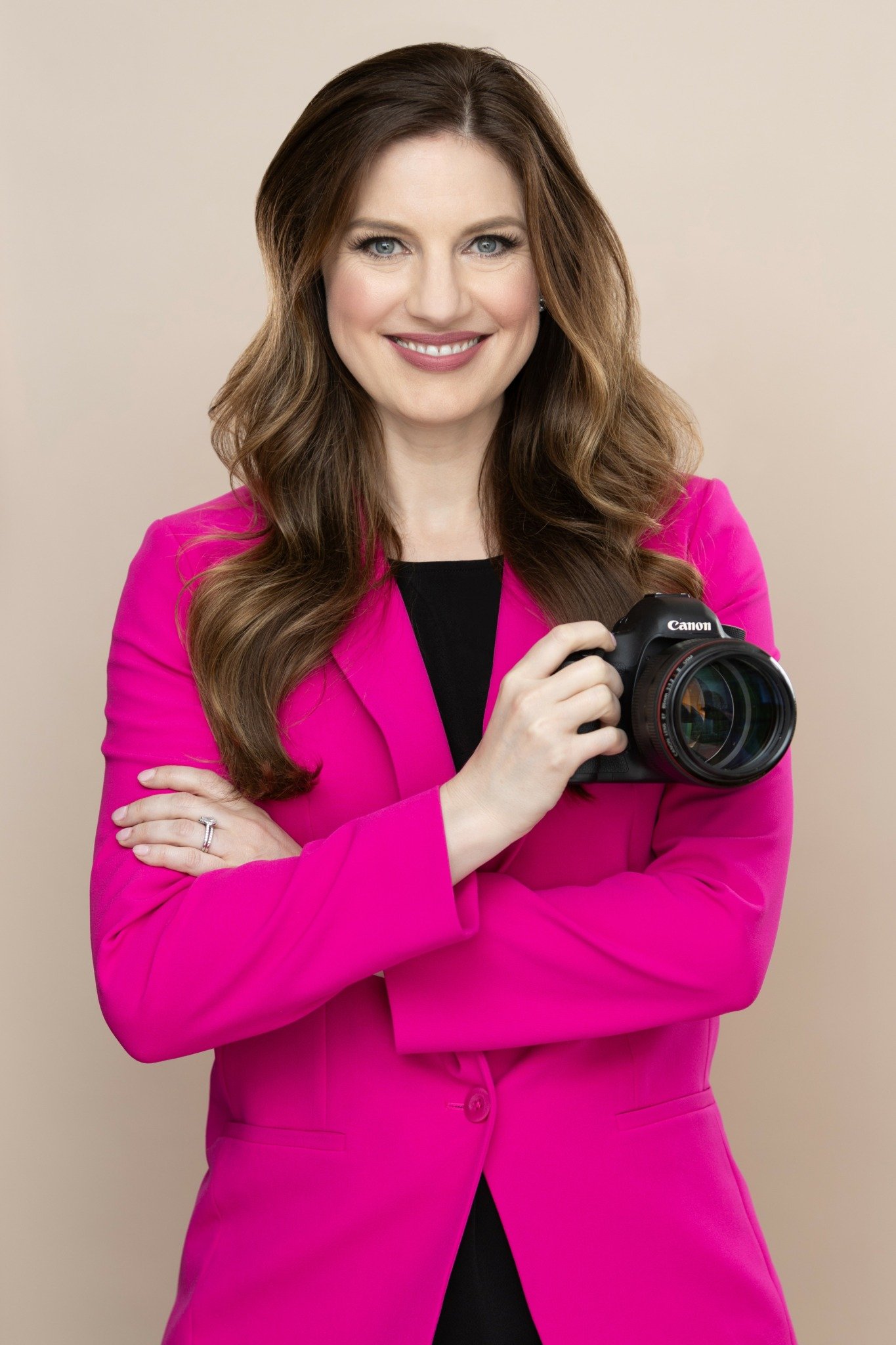Liz Hansen of Chicago Boudoir Photography headshot holding a camera