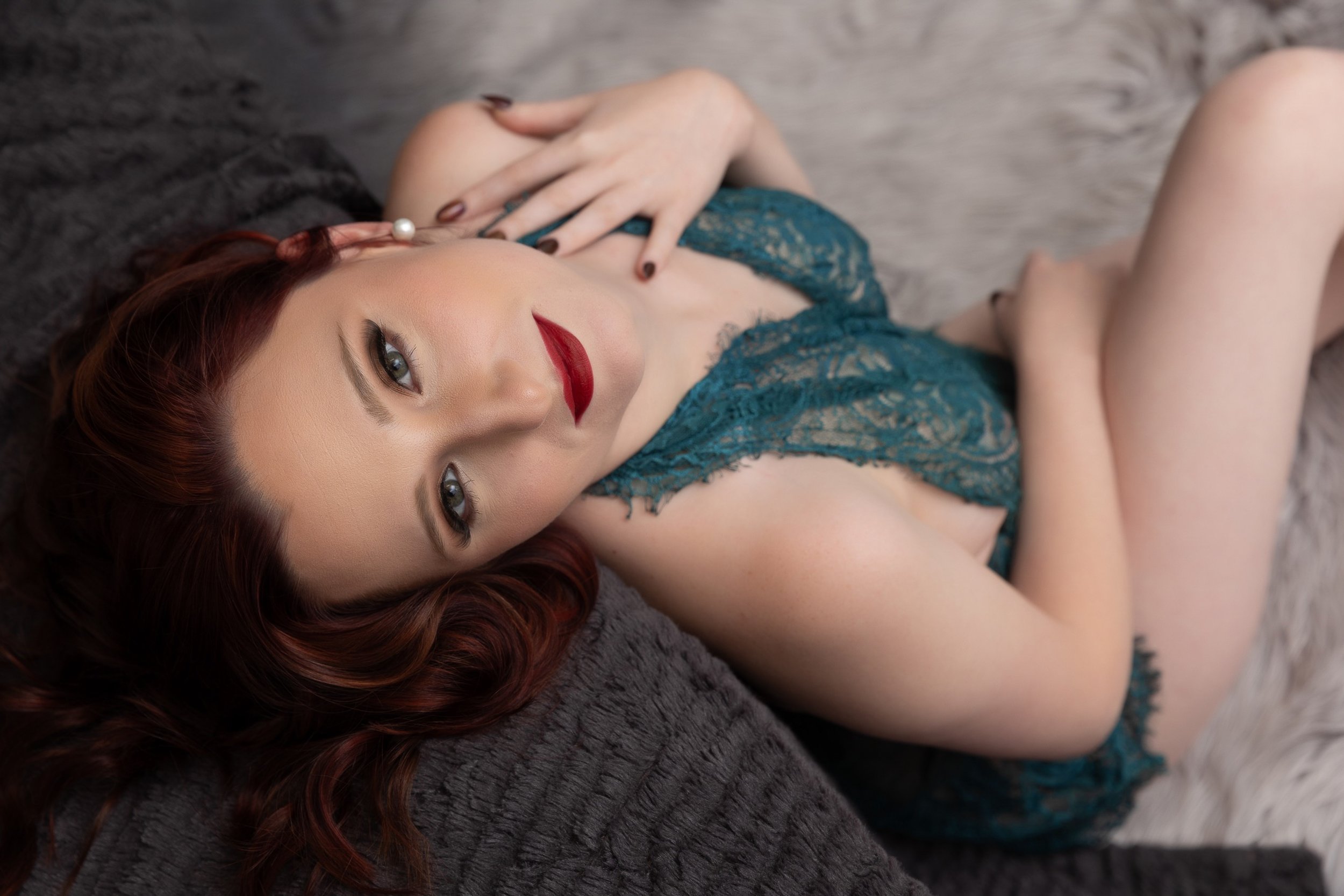 Woman posing in boudoir photos embodying Pisces zodiac traits of creativity and emotion