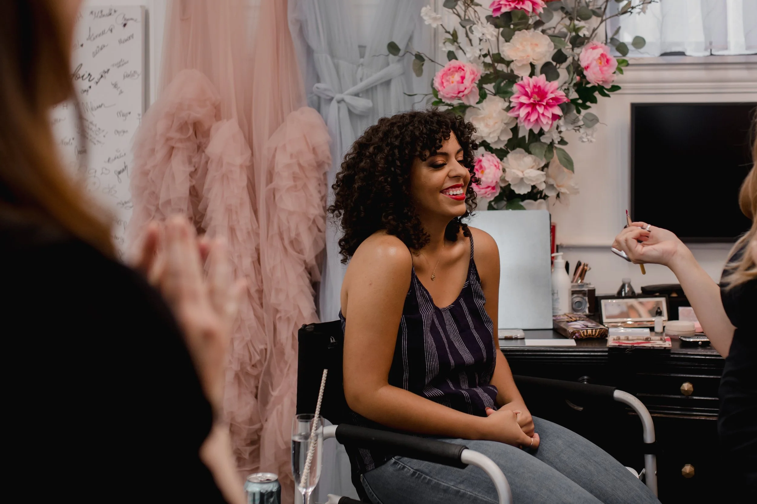 Boudoir client relaxing in makeup chair before photoshoot