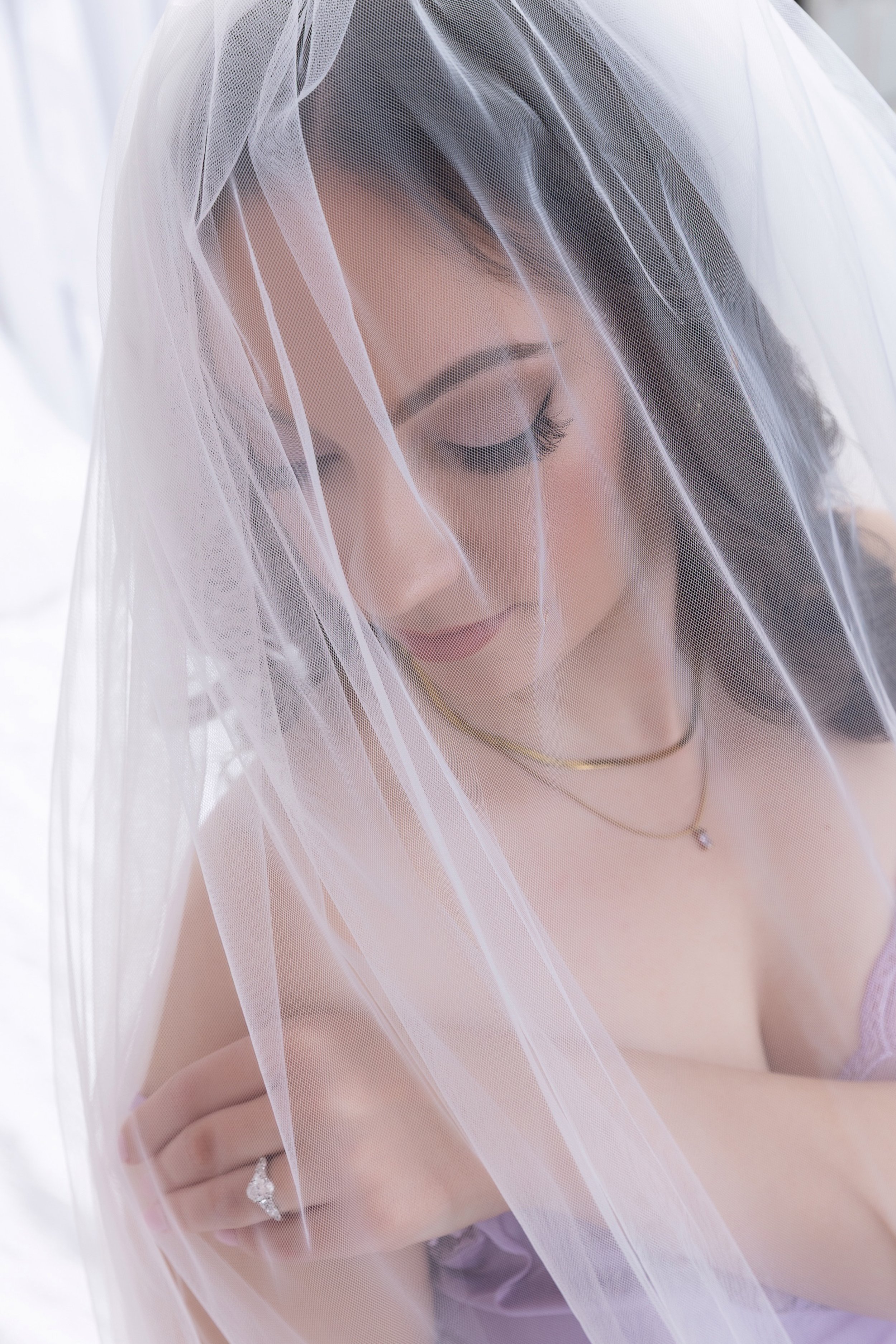Close-up of bride in lace veil during boudoir photoshoot