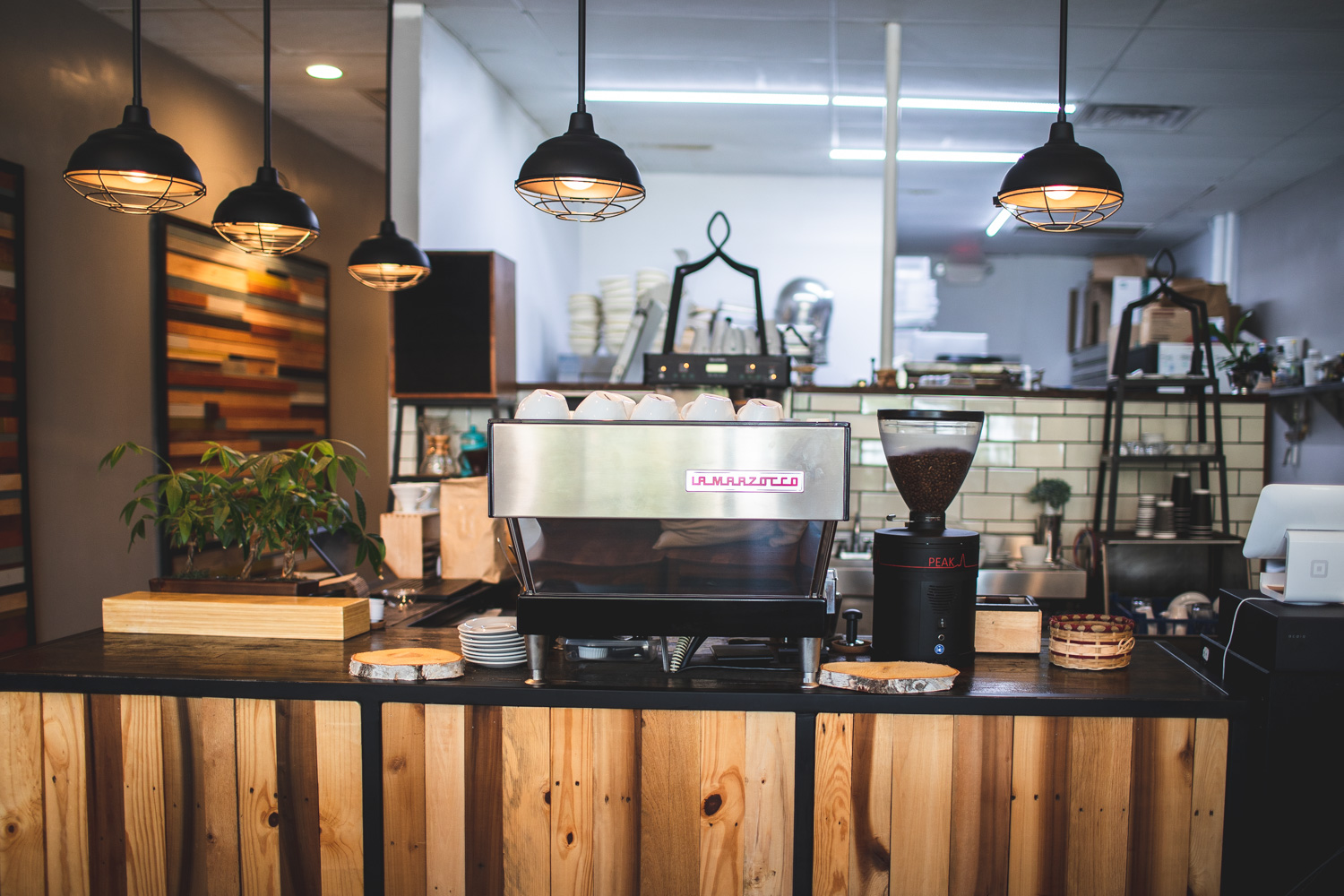 The front counter at Beans & Butter Coffeehouse. Note the wooden accents and fresh flowers.