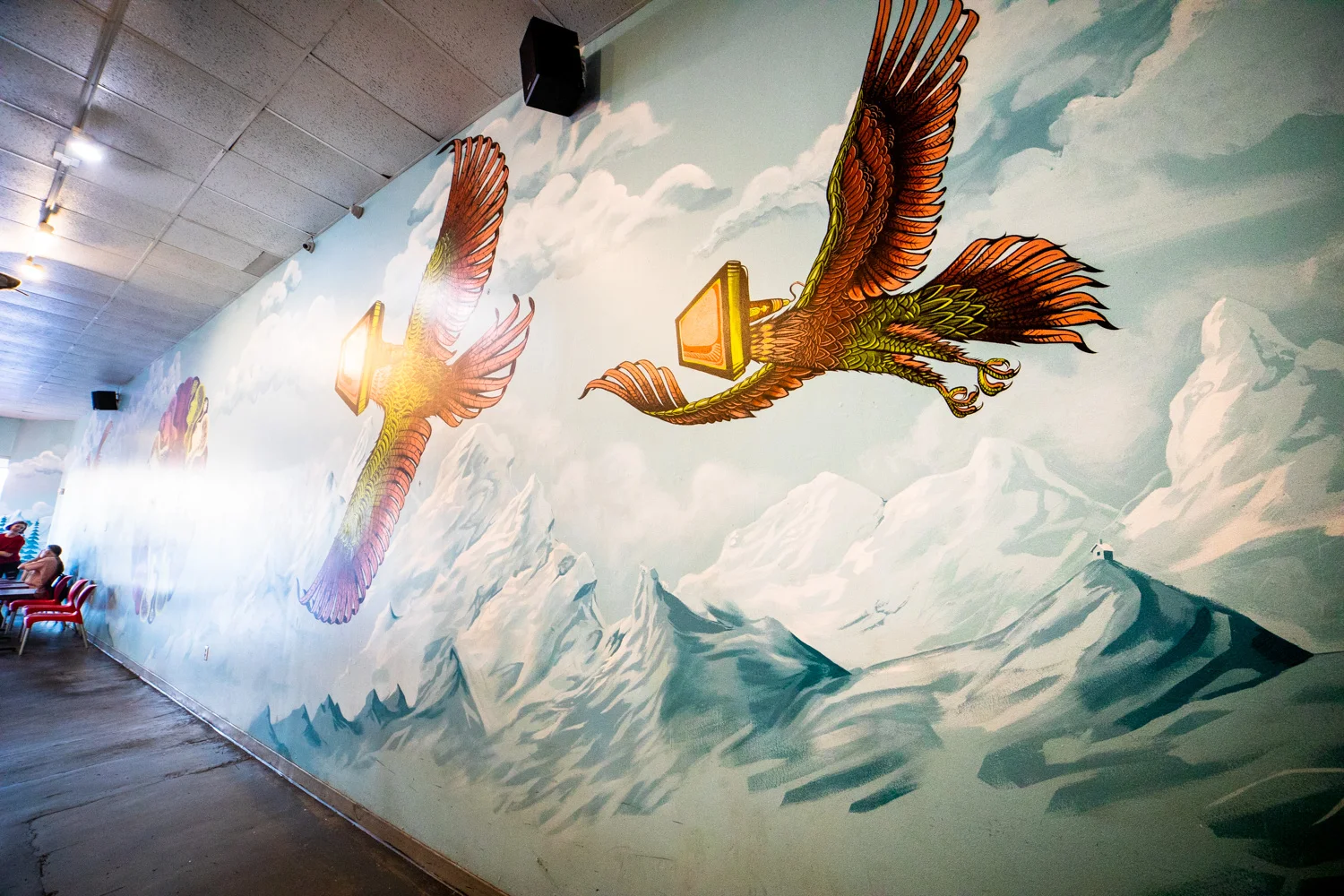Eagle mutants flying over mountains. (It would be helpful to find out if this mural has a title.)