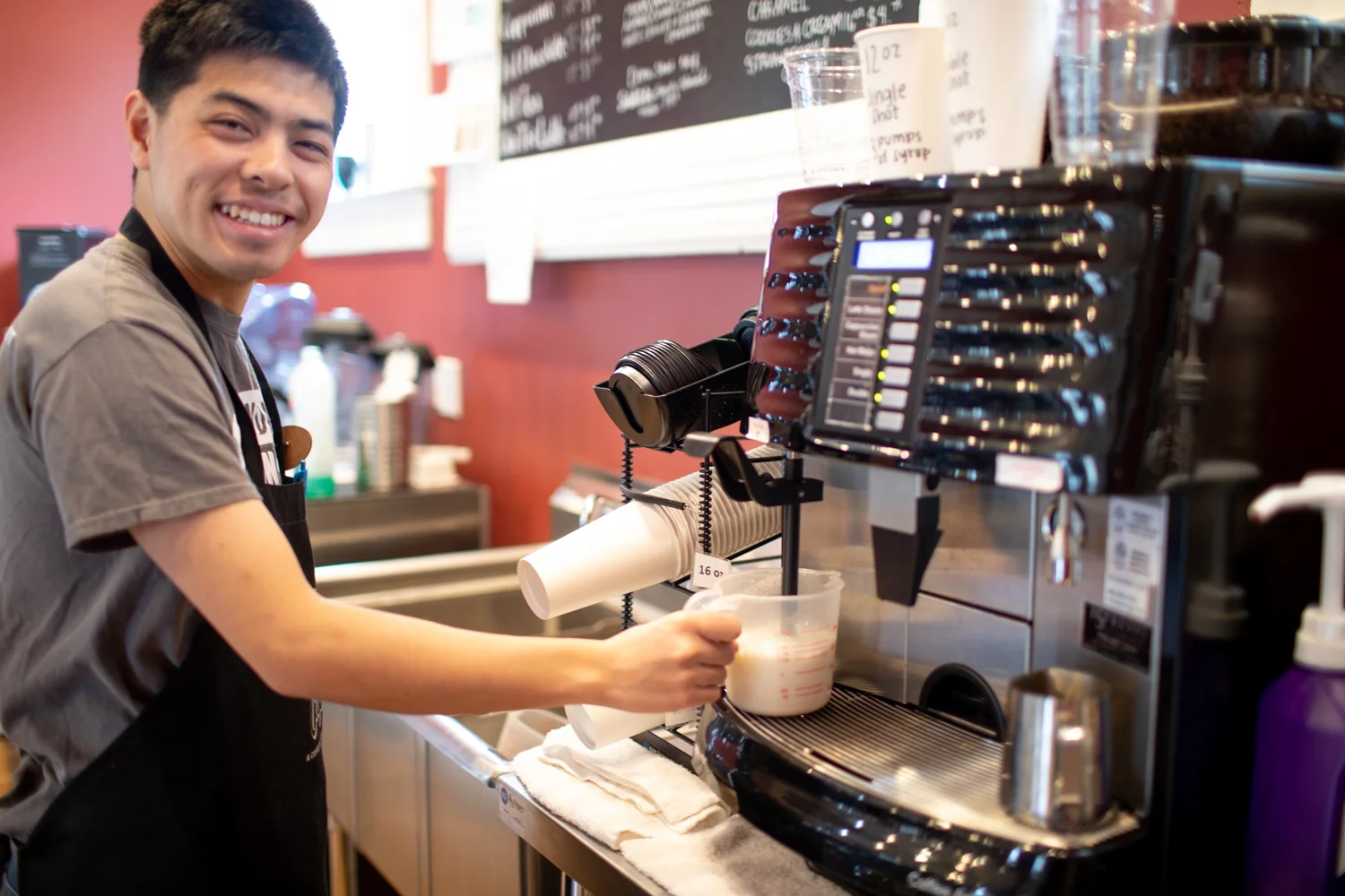 Ben warming up the milk for a coffee drink. All smiles here!