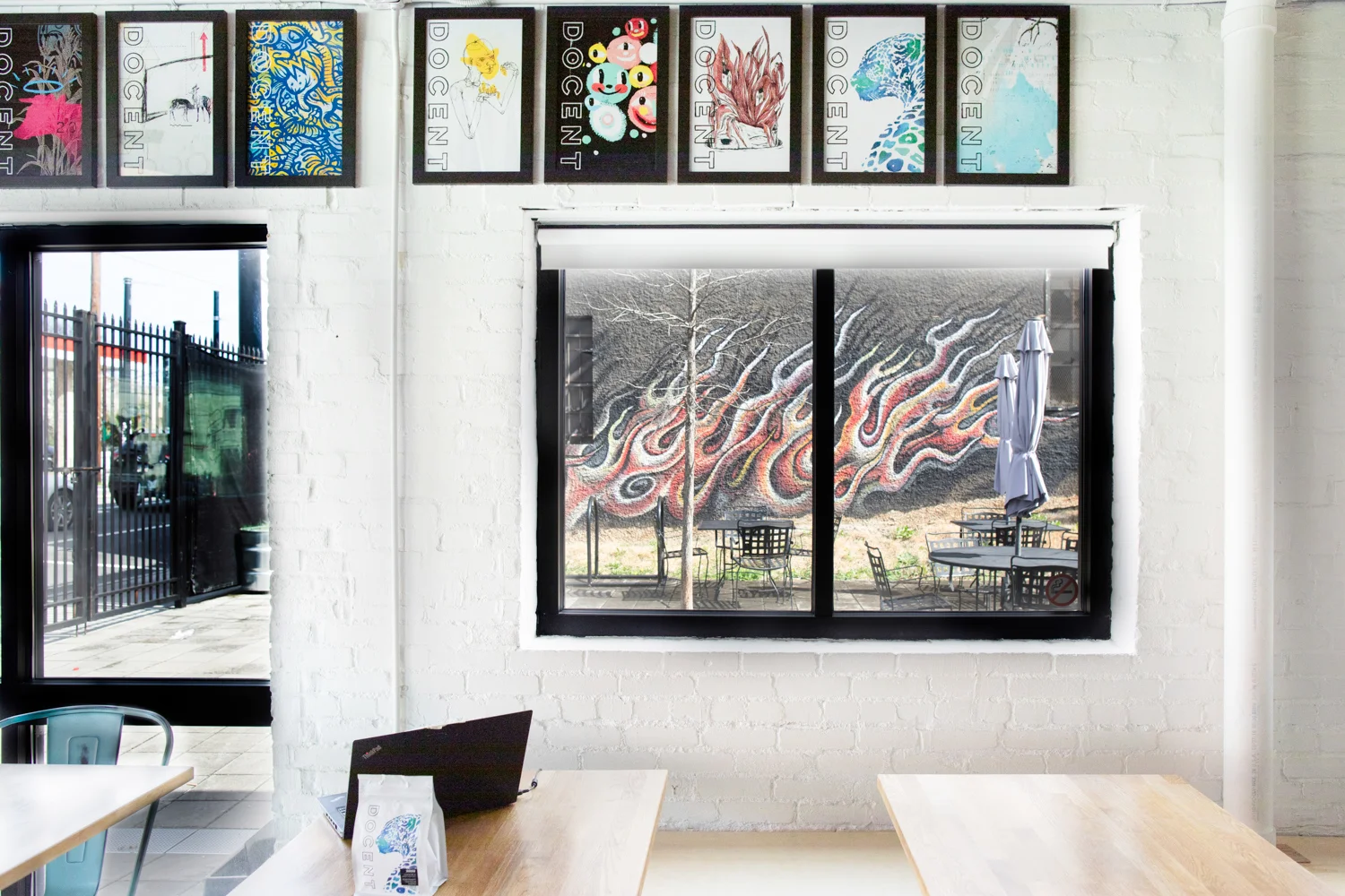 Interior of Docent Coffee. The view through the window is toward the outdoor courtyard (patio) of Docent Coffee.