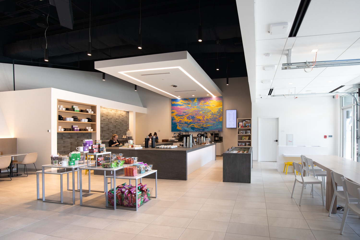 A wide-angle view of inside Xander Coffee. A hip, modern aesthetic is prevalent throughout the space.