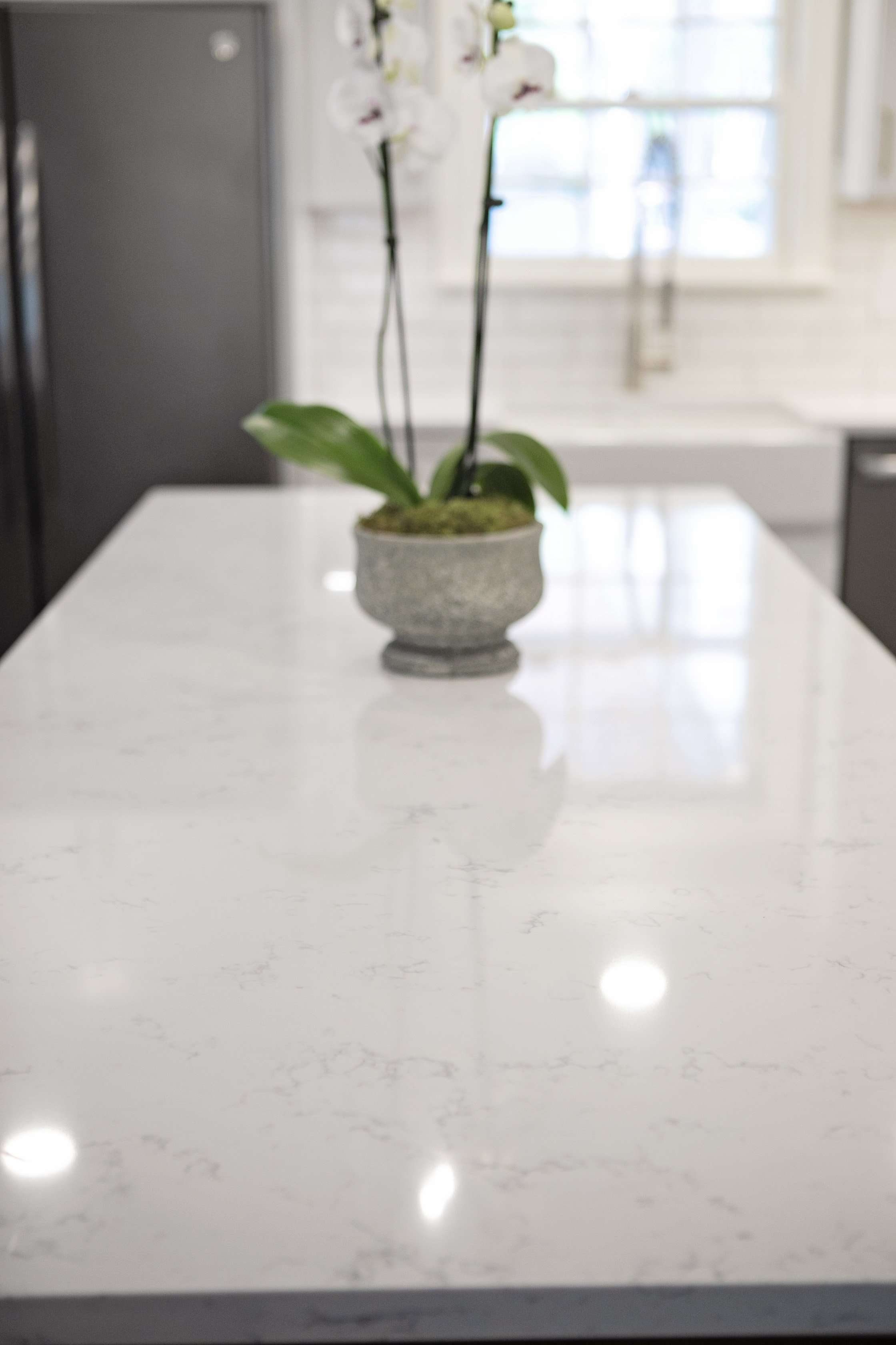 Carrara Lumos quartz countertops contrast beautifully with the wood. 