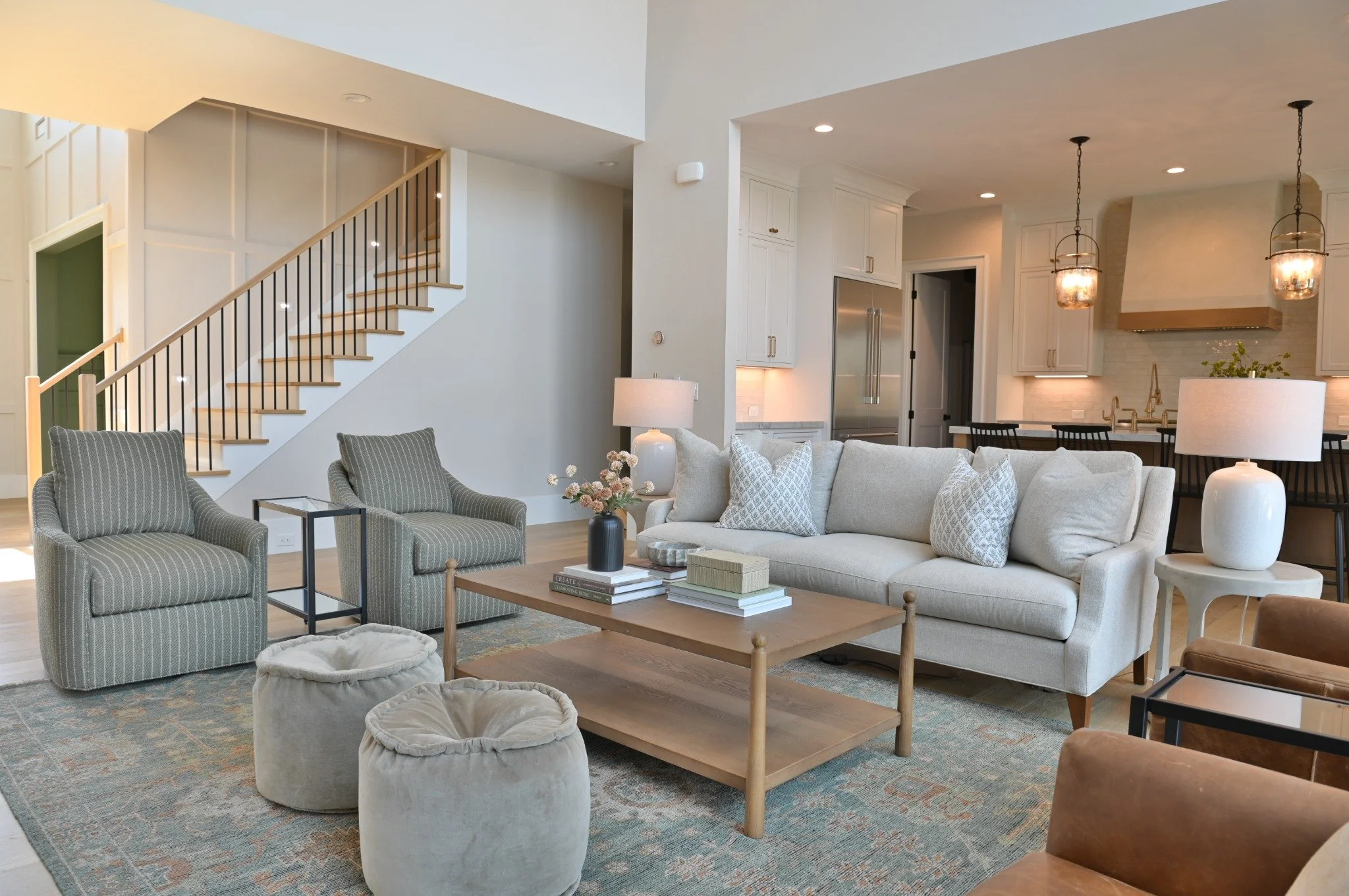 Living room with open view to custom kitchen cabinetry and island in Greensboro home