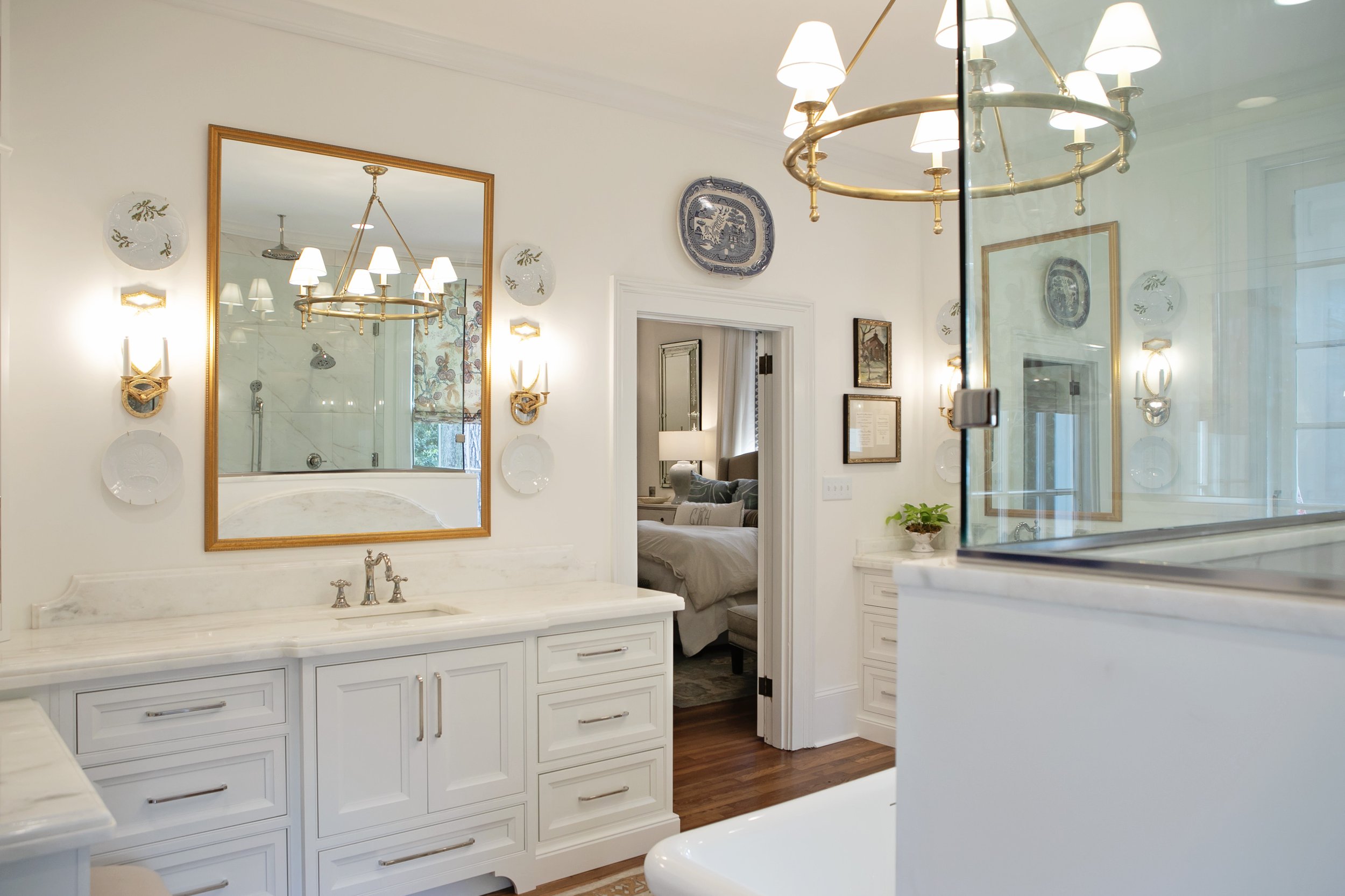 White Cabinetry in Luxurious Bathroom by Pool Brothers Cabinets + Lighting + Flooring