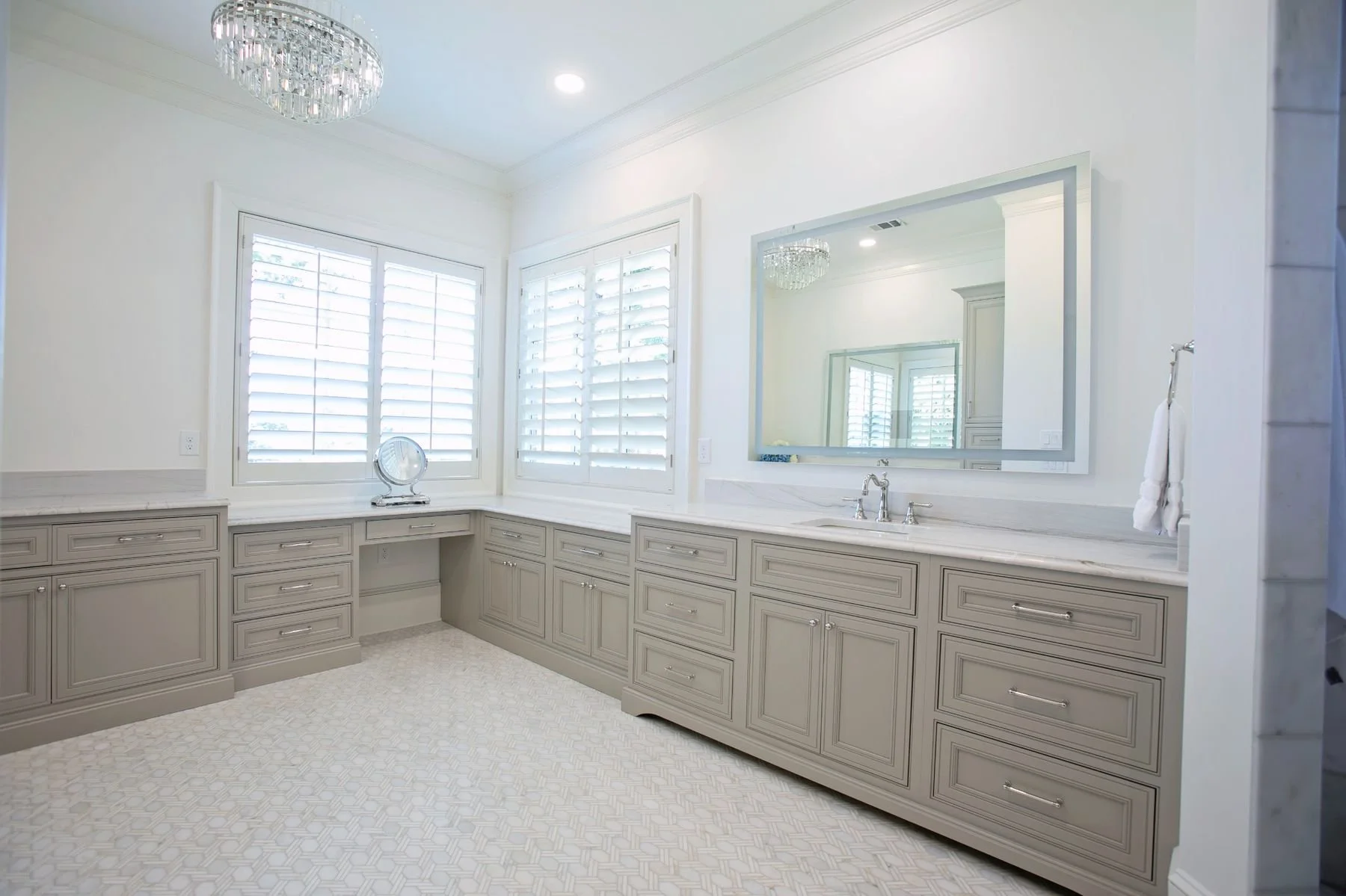 Luxury bathroom with custom painted vanity cabinets, quartz countertops, makeup station, and premium flooring in Reynolds Lake Oconee, Greensboro, GA.