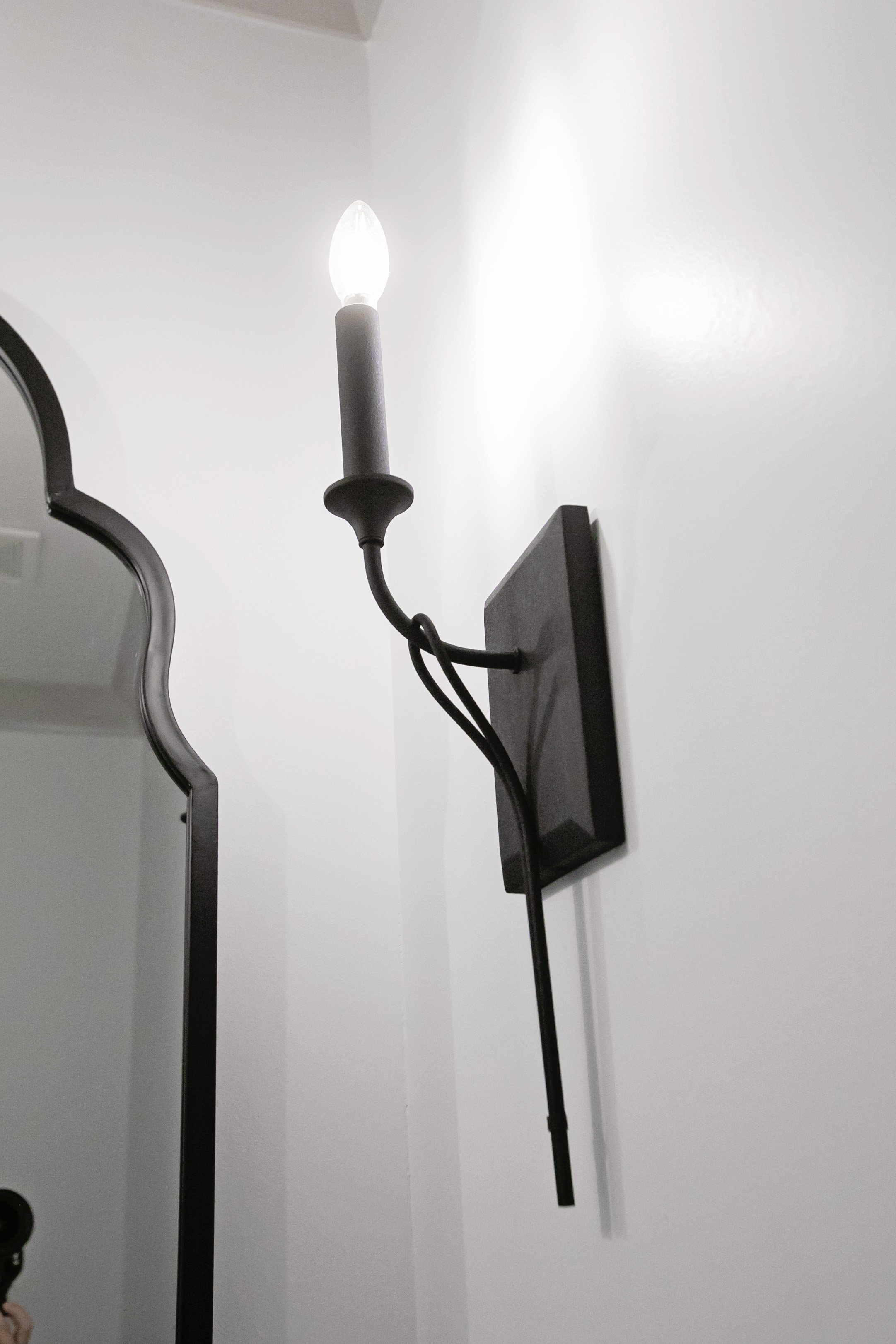 a one-light shadeless wall sconce in black iron_Pool Brothers Lighting