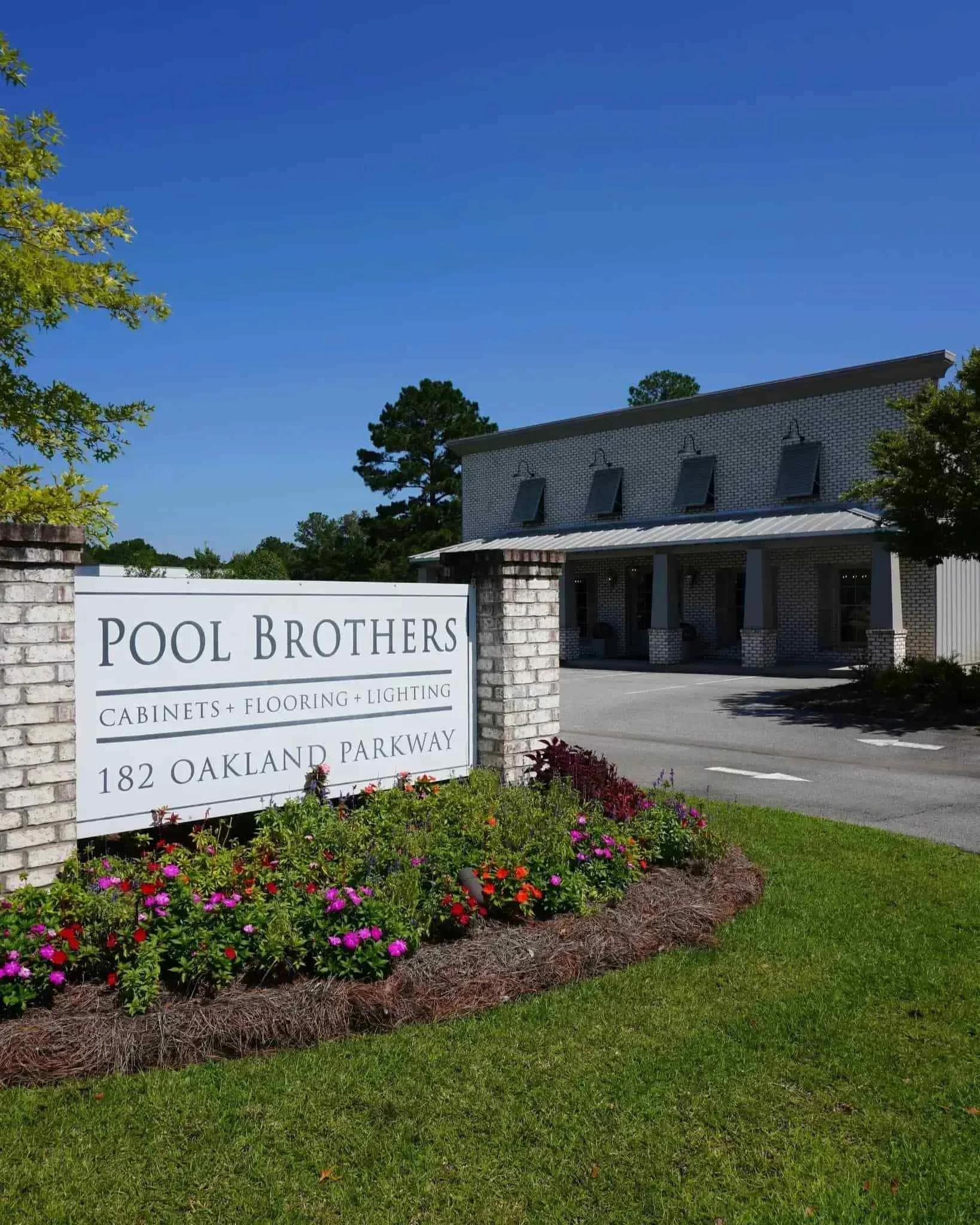 Pool Brothers Cabinets Flooring and Lighting showroom exterior in Leesburg Georgia featuring storefront signage and landscaping.