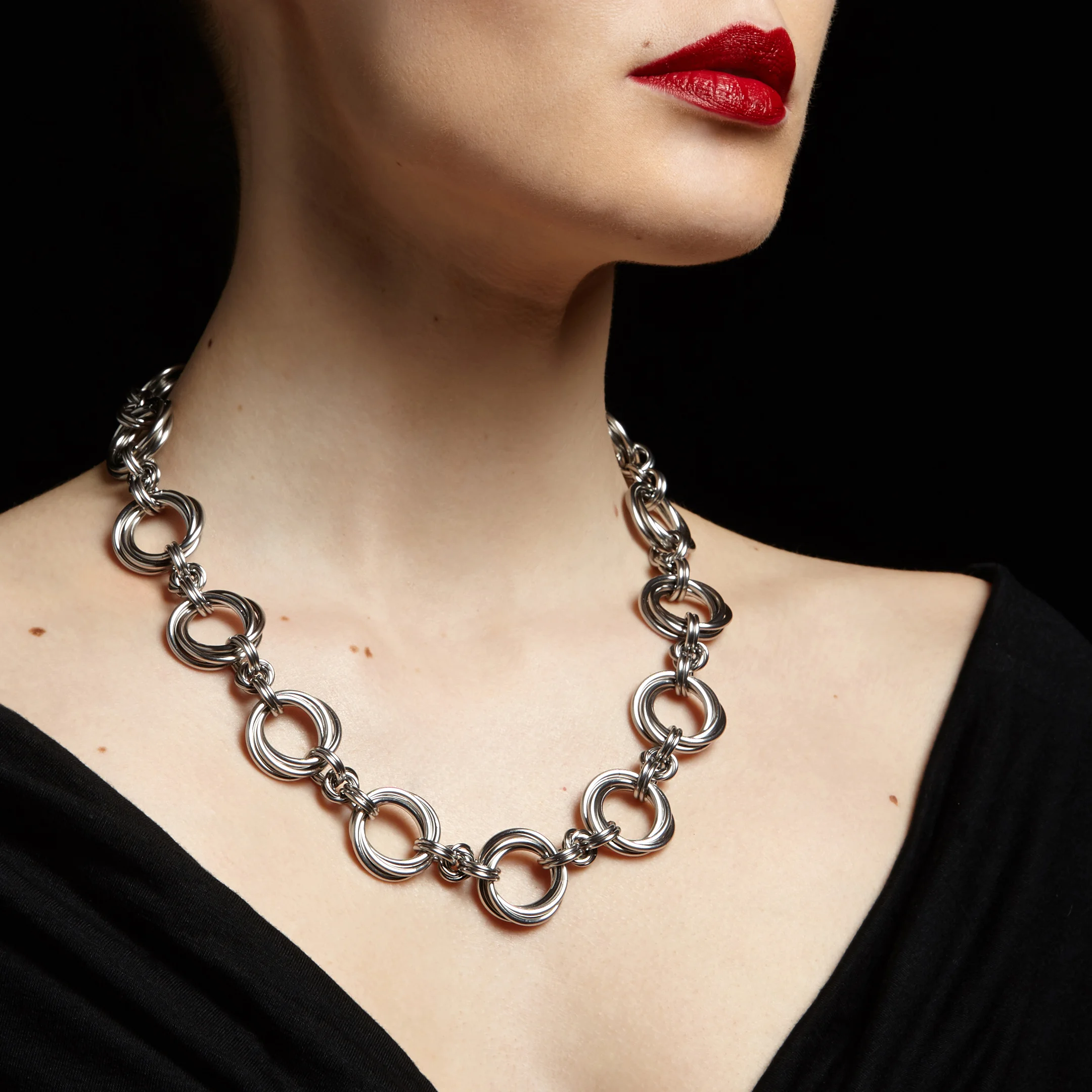 Rapt in Maille My stainless steel jewelry combines traditional patterns of chainmaille with contemporary decorative elements and a modern, urban design sensibility. A significant focus of my work lies in the provocative integration of masculine vs. feminine. I build the chainmaille by opening and closing individual links to weave them together in a specific pattern. If a piece has any length of chain in the design, each chain is painstakingly measured and cut so that the design lays properly on the wearer, with placement, weight, and gravity playing a major role. – Melissa Banks Website: http://www.raptinmaille.com