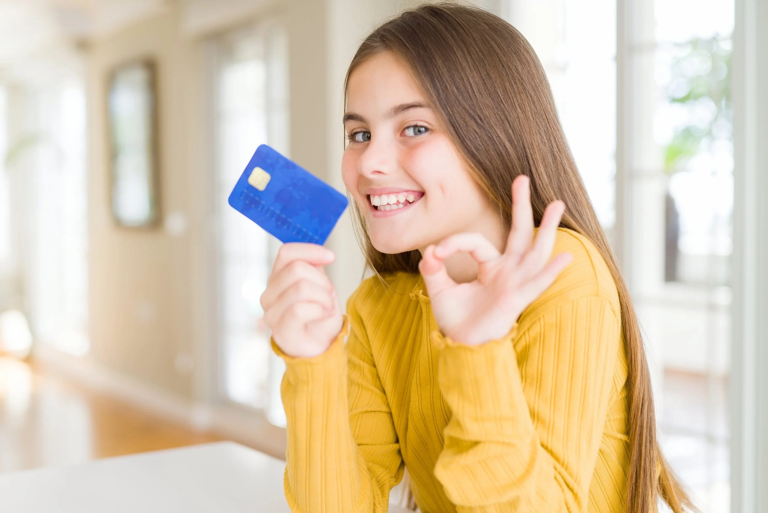 young teen with first debit card