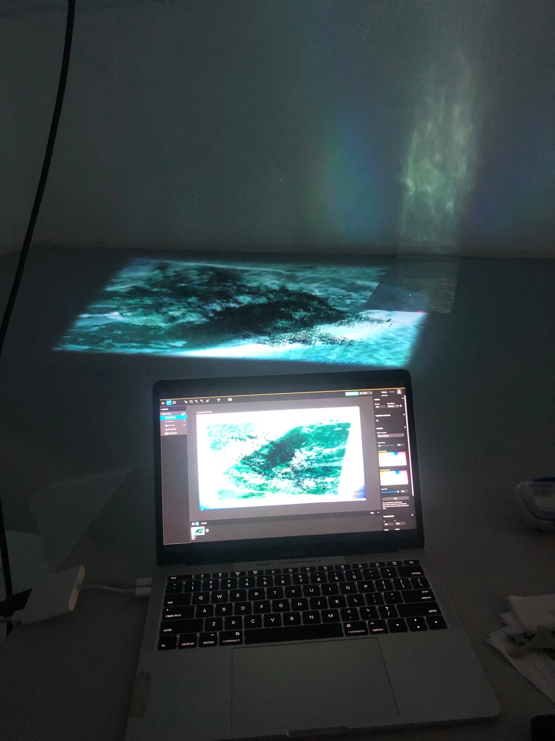 Setting up the video footage and Generative particle effects in Lightforms Creator software. Also testing caustic effects of projection with holographic material (on right)
