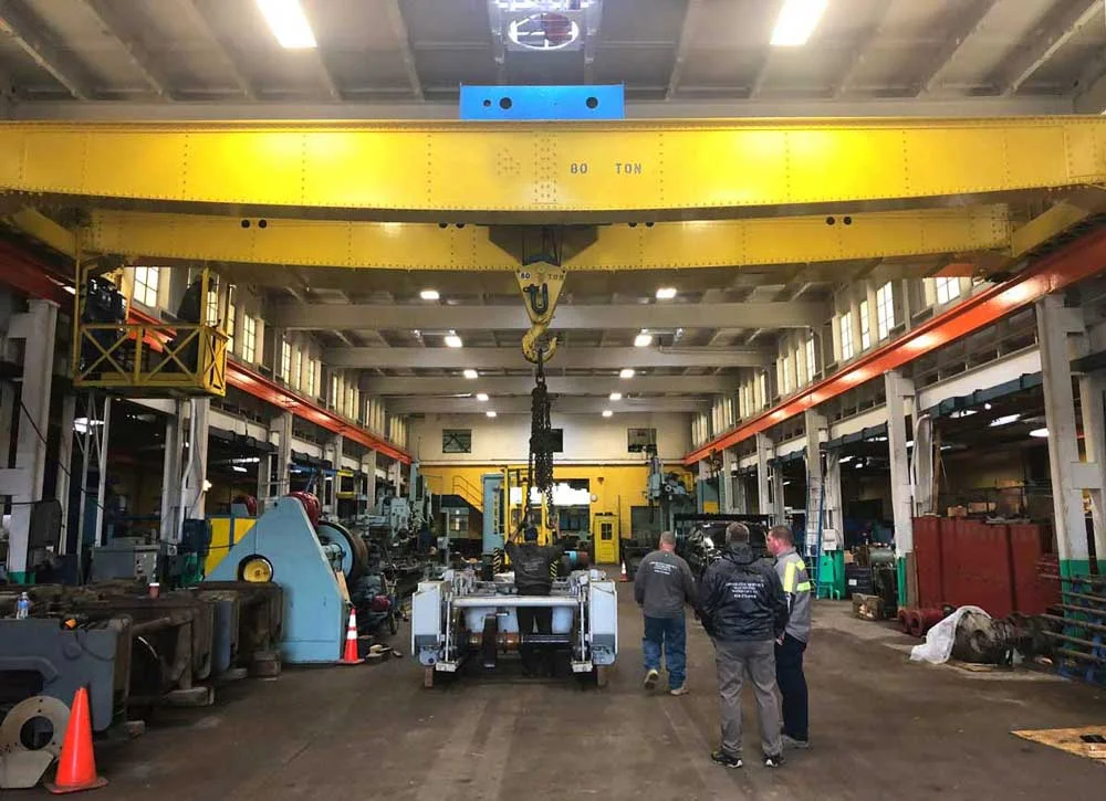 Offloading the damaged locomotive truck at FMW’s machine shop - the donor trucks can be seen at left.