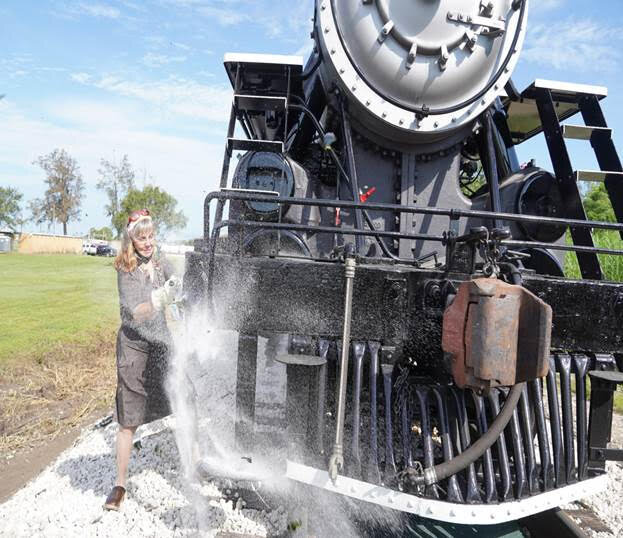  The steam engine was christened with a champagne bottle of sugar, broken by Barbara Buker, wife of U.S. Sugar president and CEO Robert Buker. 