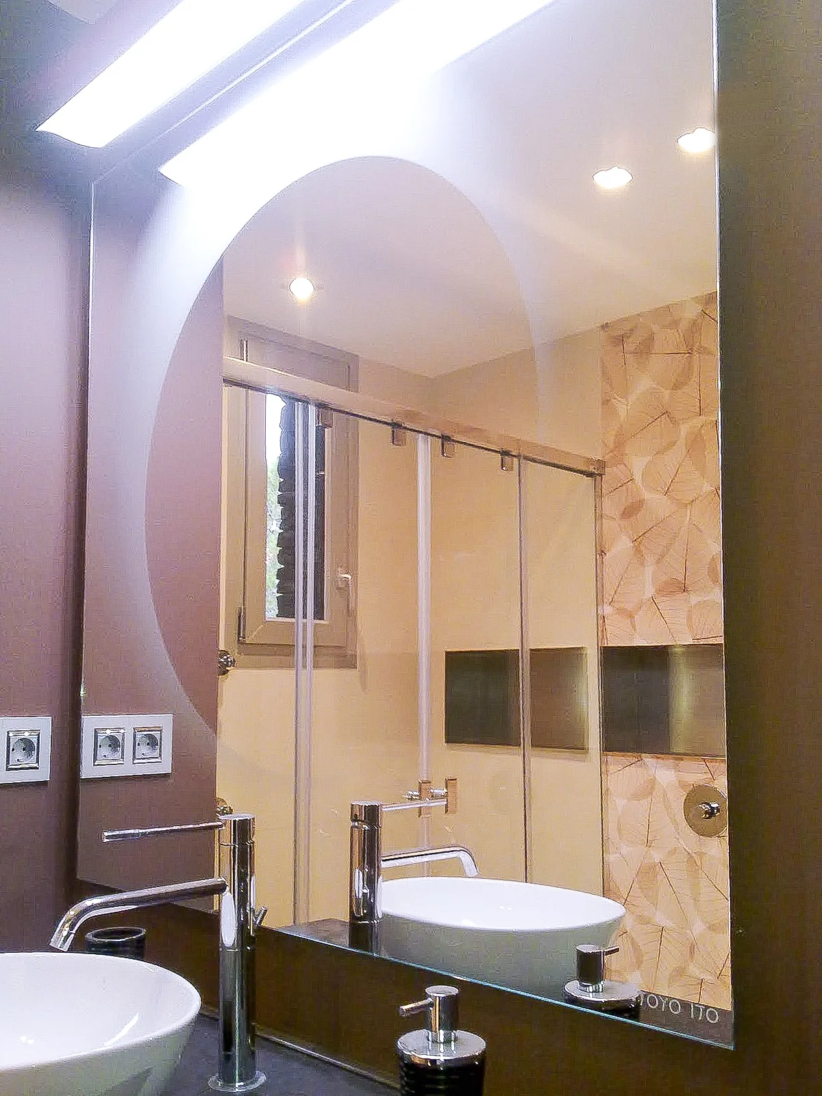 modern bathroom mirror with a wall-sconce on top