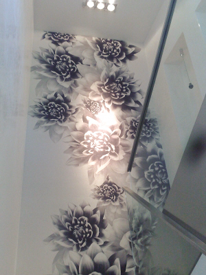 staircase wall with a white and black mural wallpaper with flowers