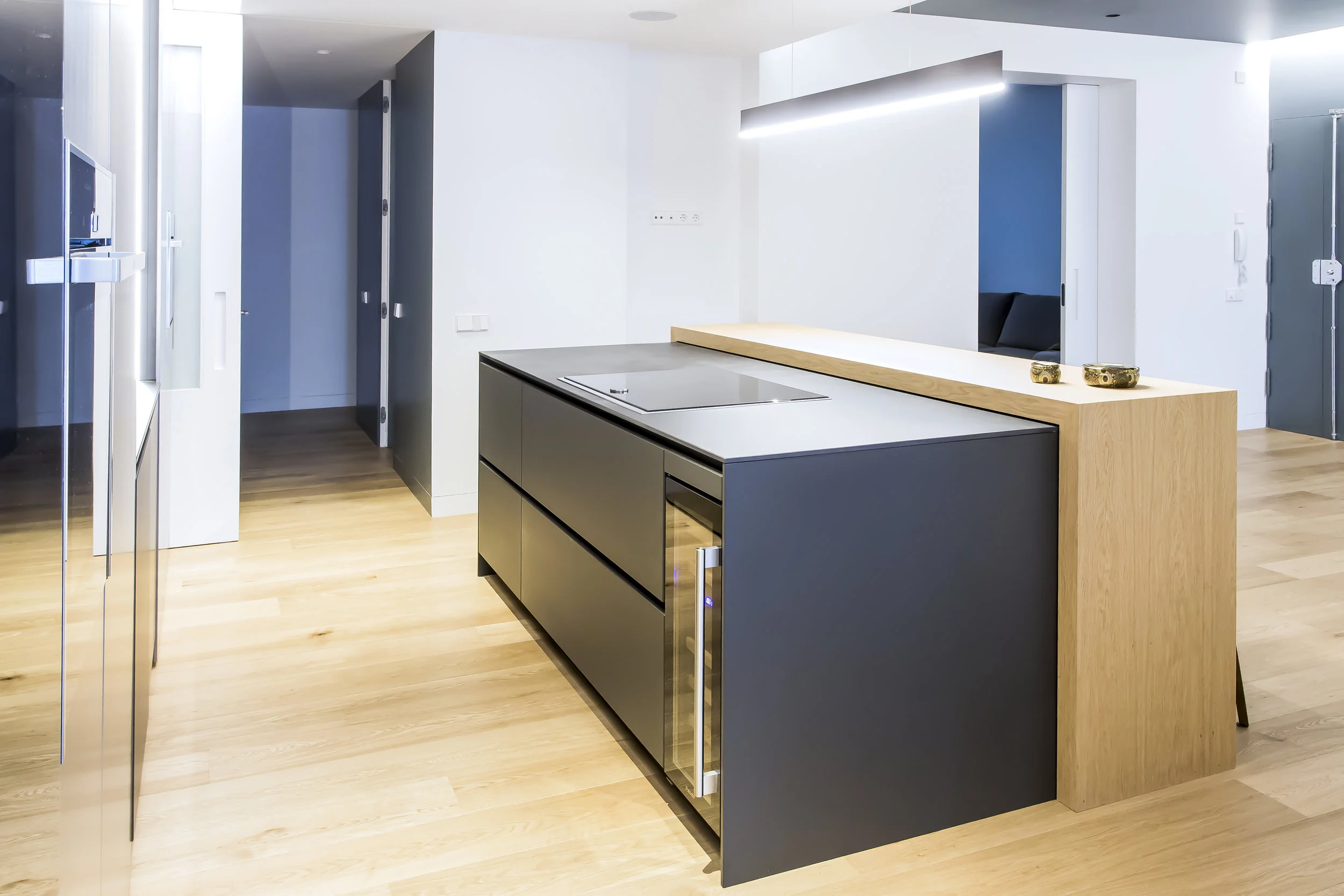 oak waterfall countertop wrapping the titanium finished cabinets to add a warm touch to the kitchen remodel.
